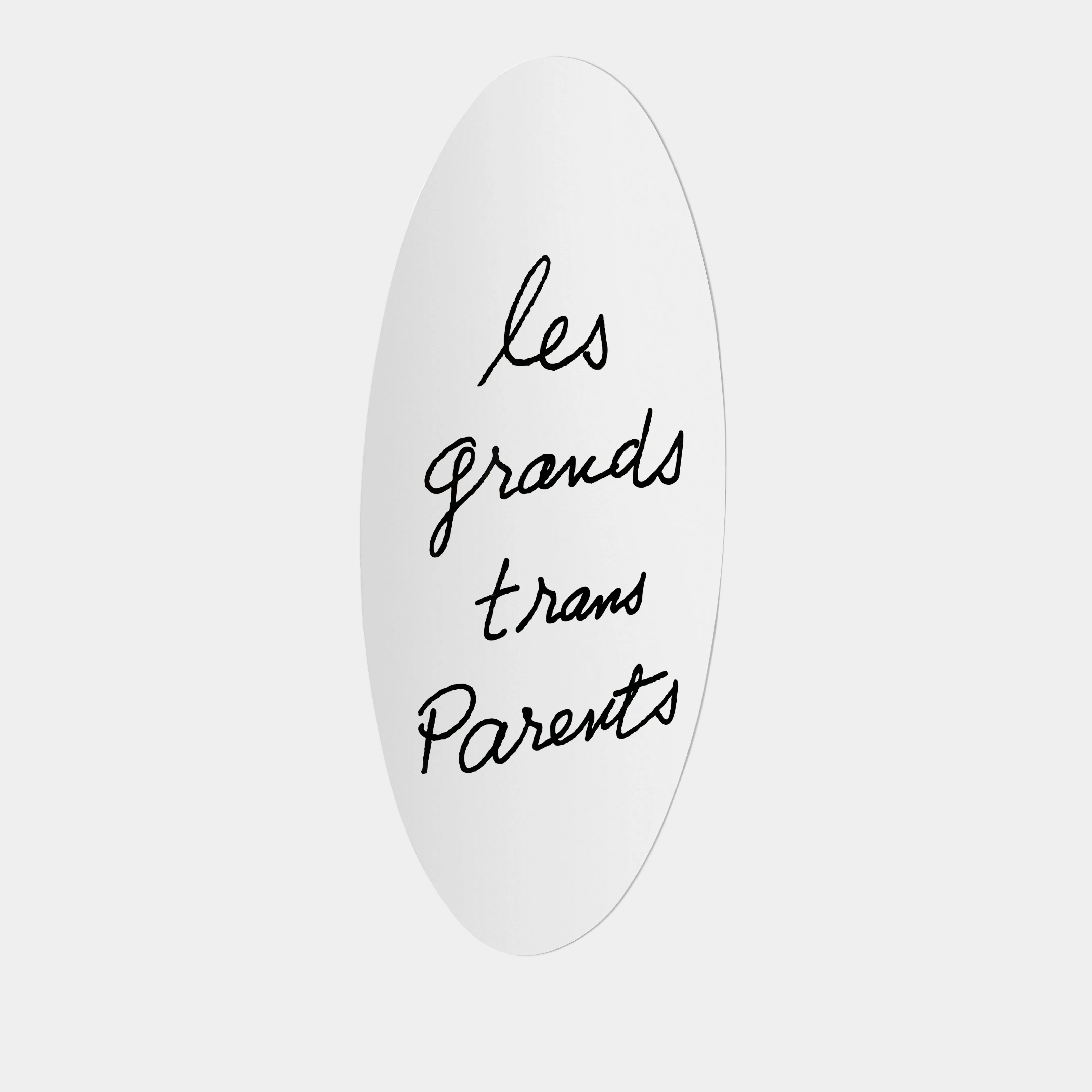 The Cassina Man Ray Les Grands Trans Parent Mirror by Cassina features an oval white frame with the handwritten French phrase "les grands trans Parents" in black cursive.