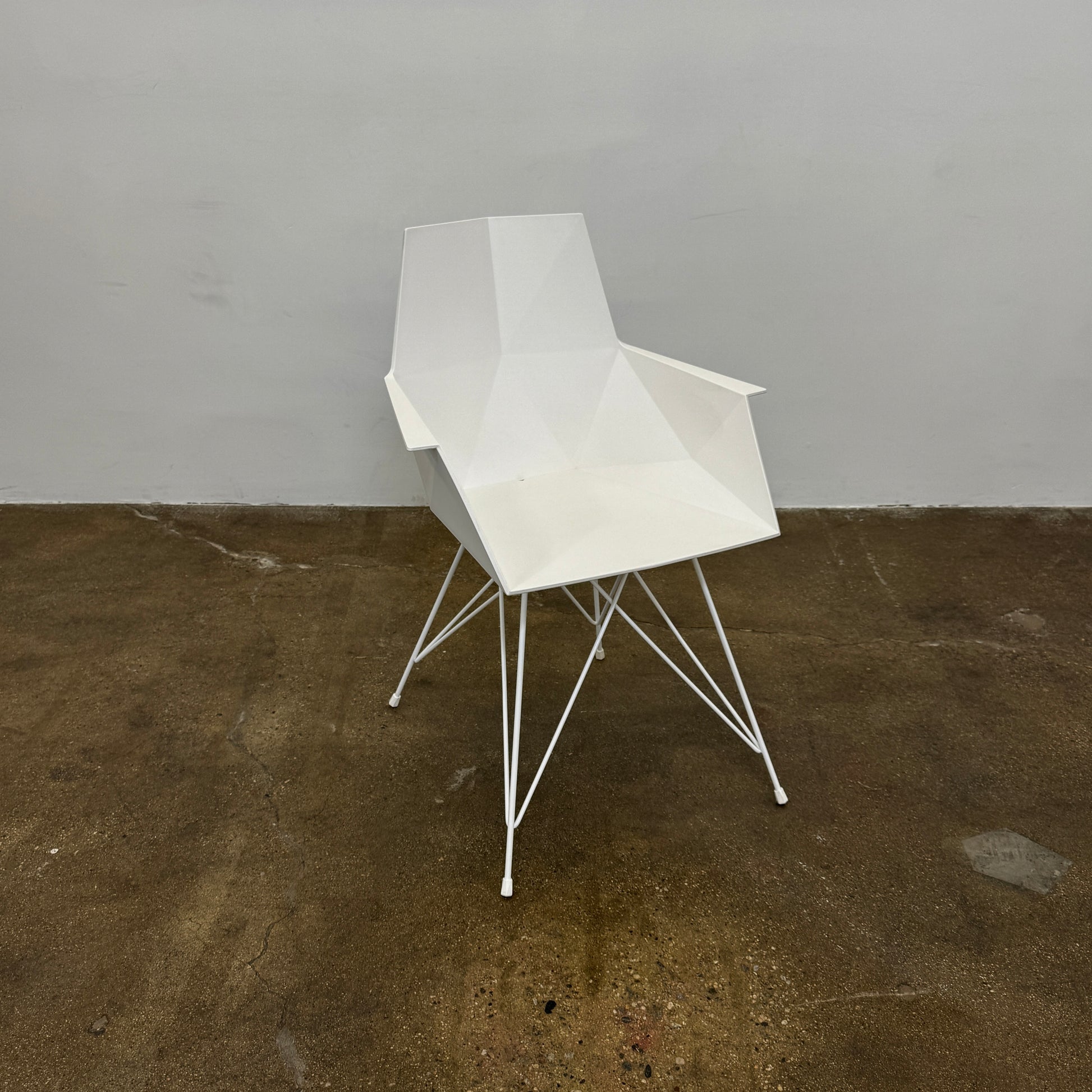Four Vondom Faz Armchairs with steel bases, designed by Vondom, are arranged in two rows against a plain white background, highlighting their modern geometric style. Set includes four chairs.