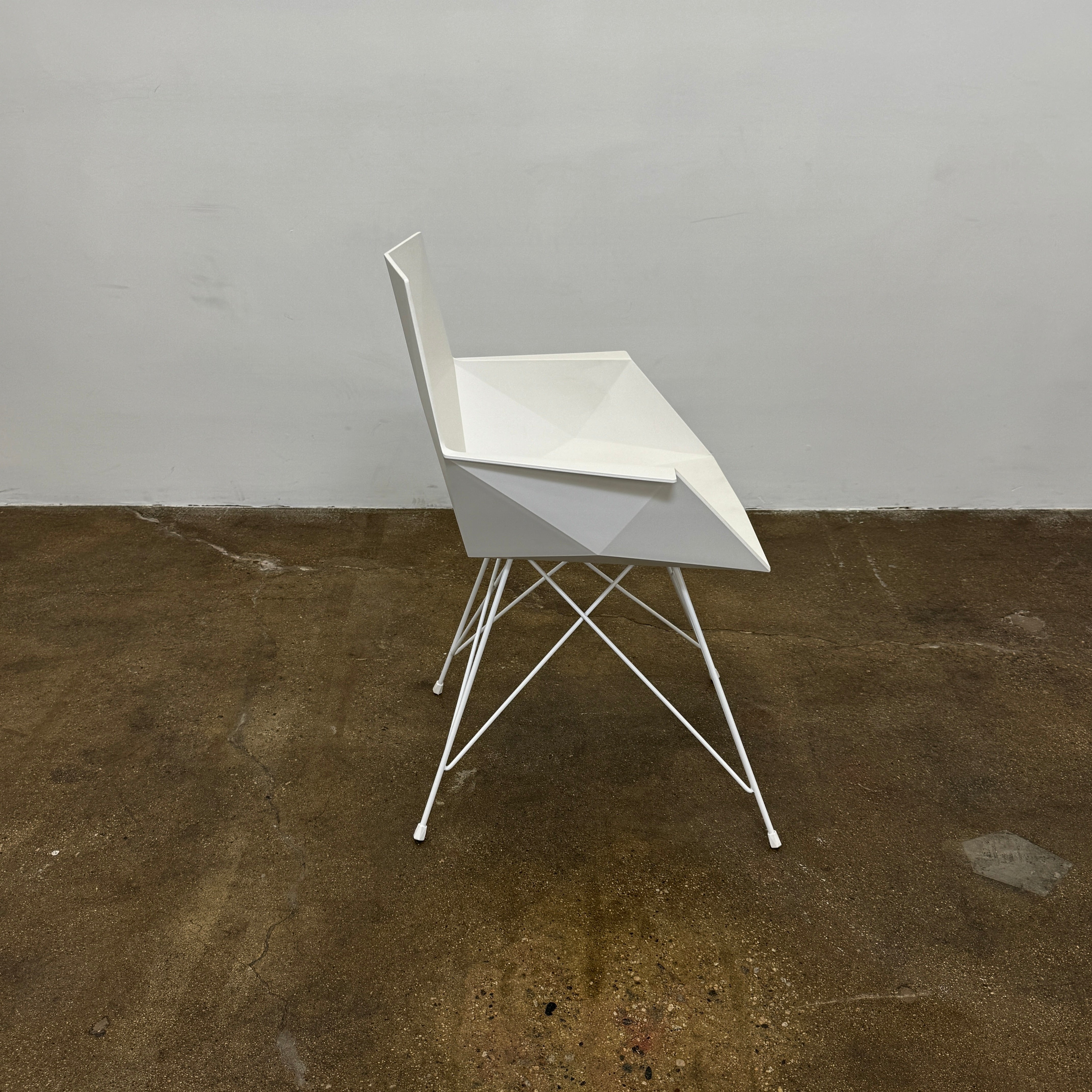 Four Vondom Faz Armchairs with steel bases, designed by Vondom, are arranged in two rows against a plain white background, highlighting their modern geometric style. Set includes four chairs.