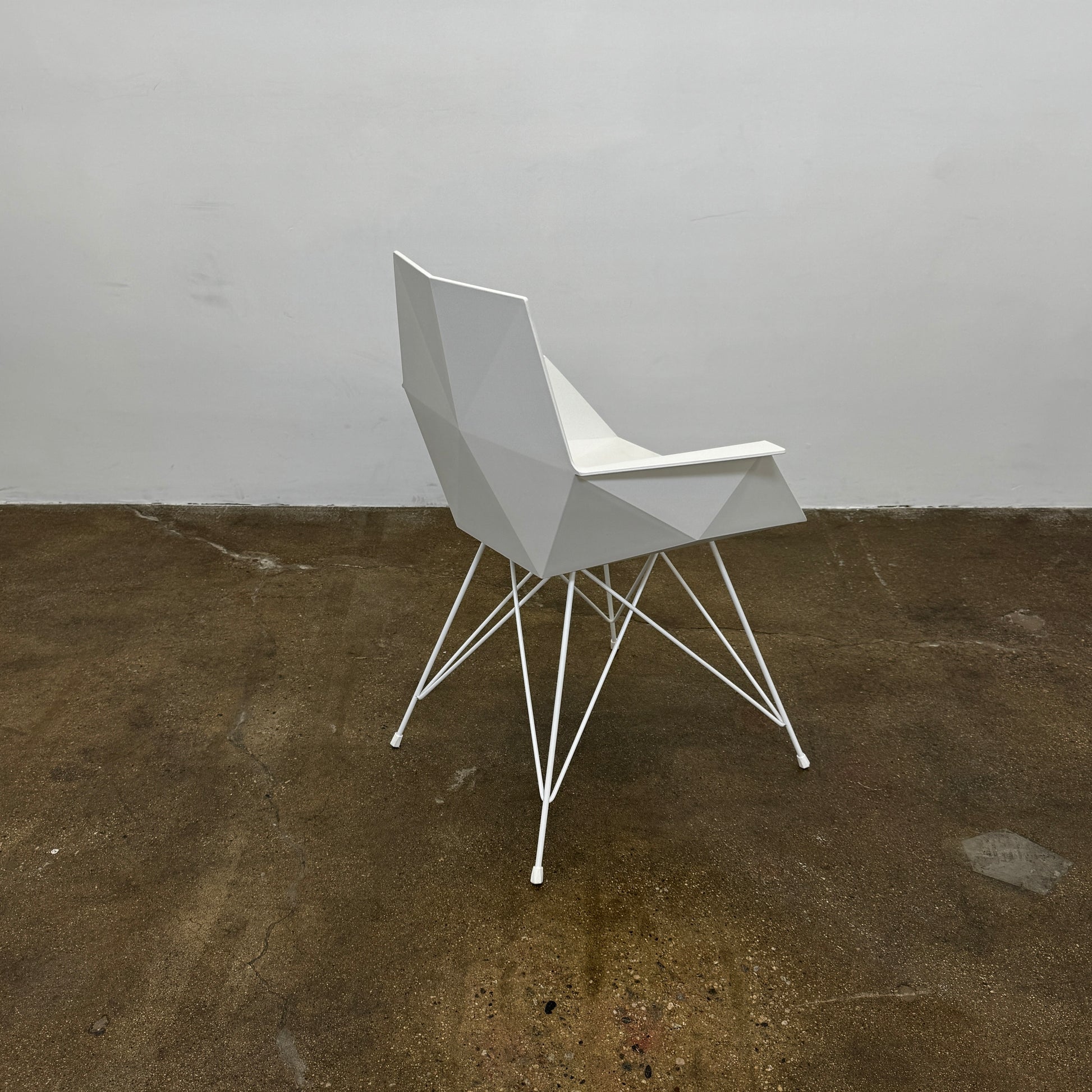 Four Vondom Faz Armchairs with steel bases, designed by Vondom, are arranged in two rows against a plain white background, highlighting their modern geometric style. Set includes four chairs.