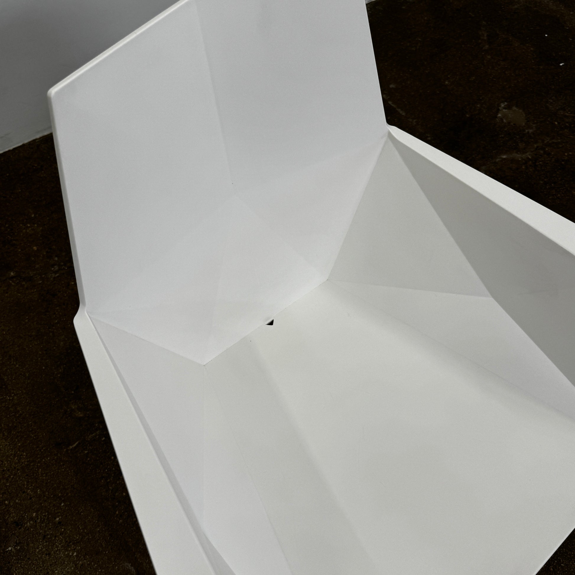 Four Vondom Faz Armchairs with steel bases, designed by Vondom, are arranged in two rows against a plain white background, highlighting their modern geometric style. Set includes four chairs.