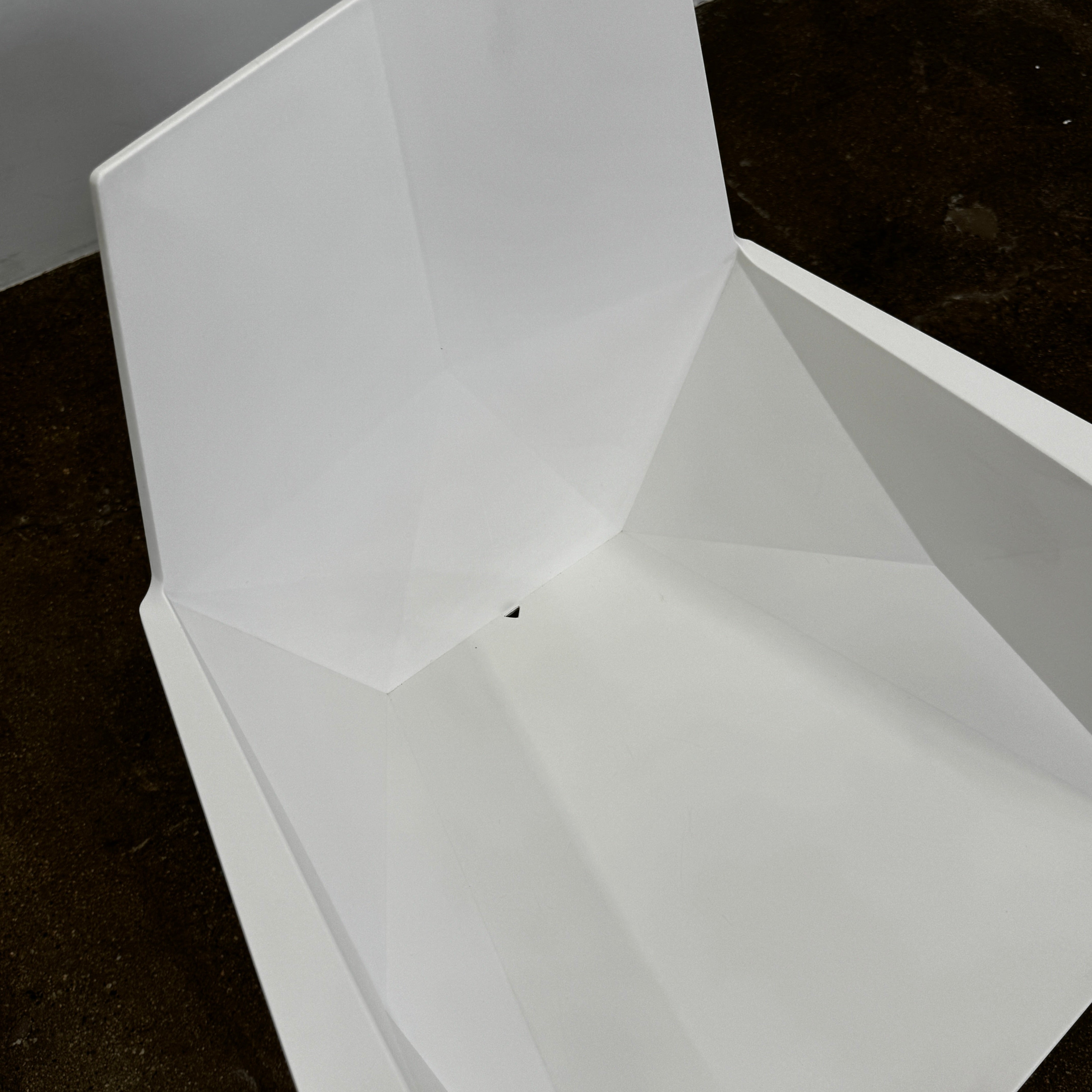 Four Vondom Faz Armchairs with steel bases, designed by Vondom, are arranged in two rows against a plain white background, highlighting their modern geometric style. Set includes four chairs.