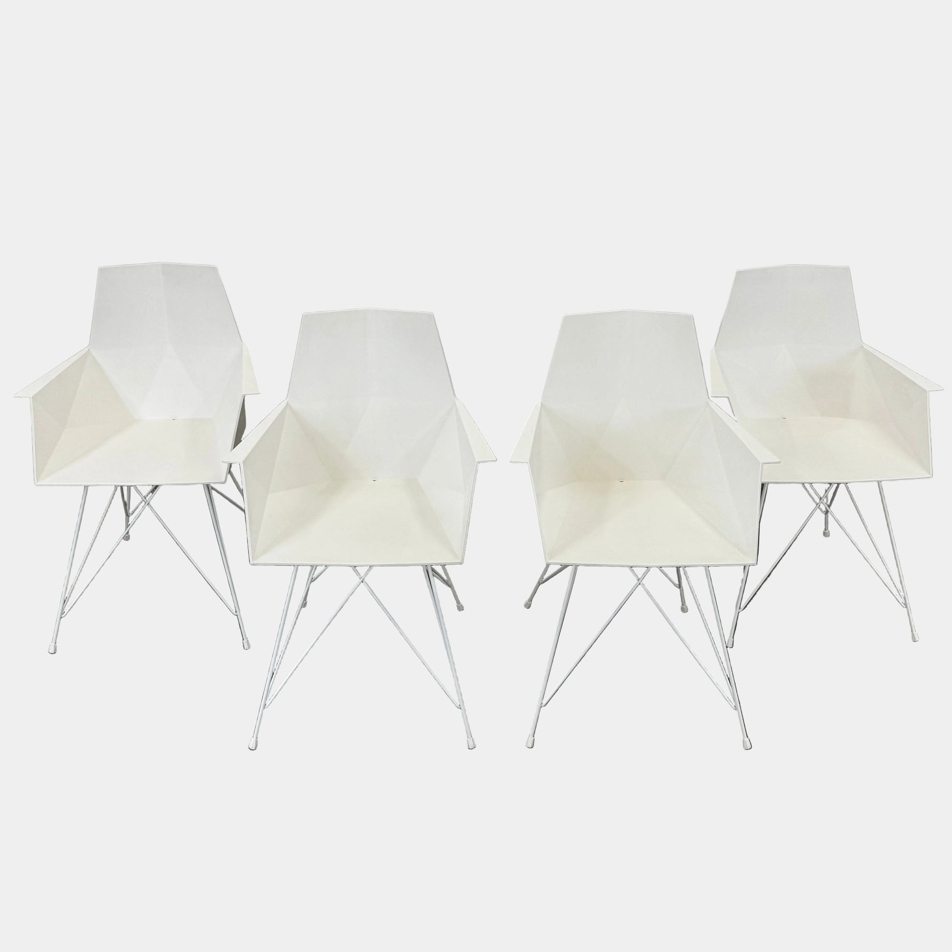 Four Vondom Faz Armchairs with steel bases, designed by Vondom, are arranged in two rows against a plain white background, highlighting their modern geometric style. Set includes four chairs.