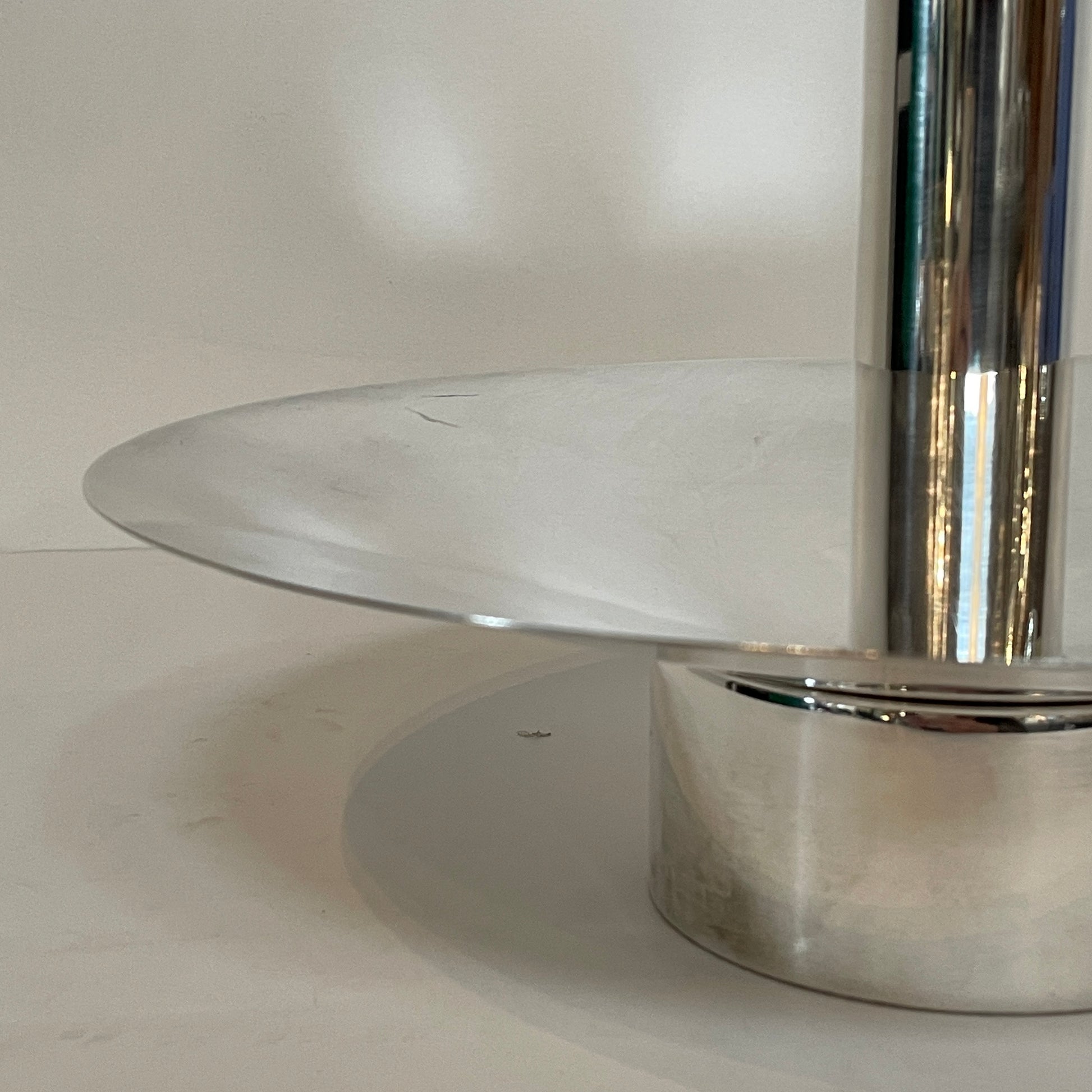 An Enzo Mari-inspired, tiered metal Driade Silver Fruit Stand Centerpiece with a reflective silver finish, isolated on a white background.