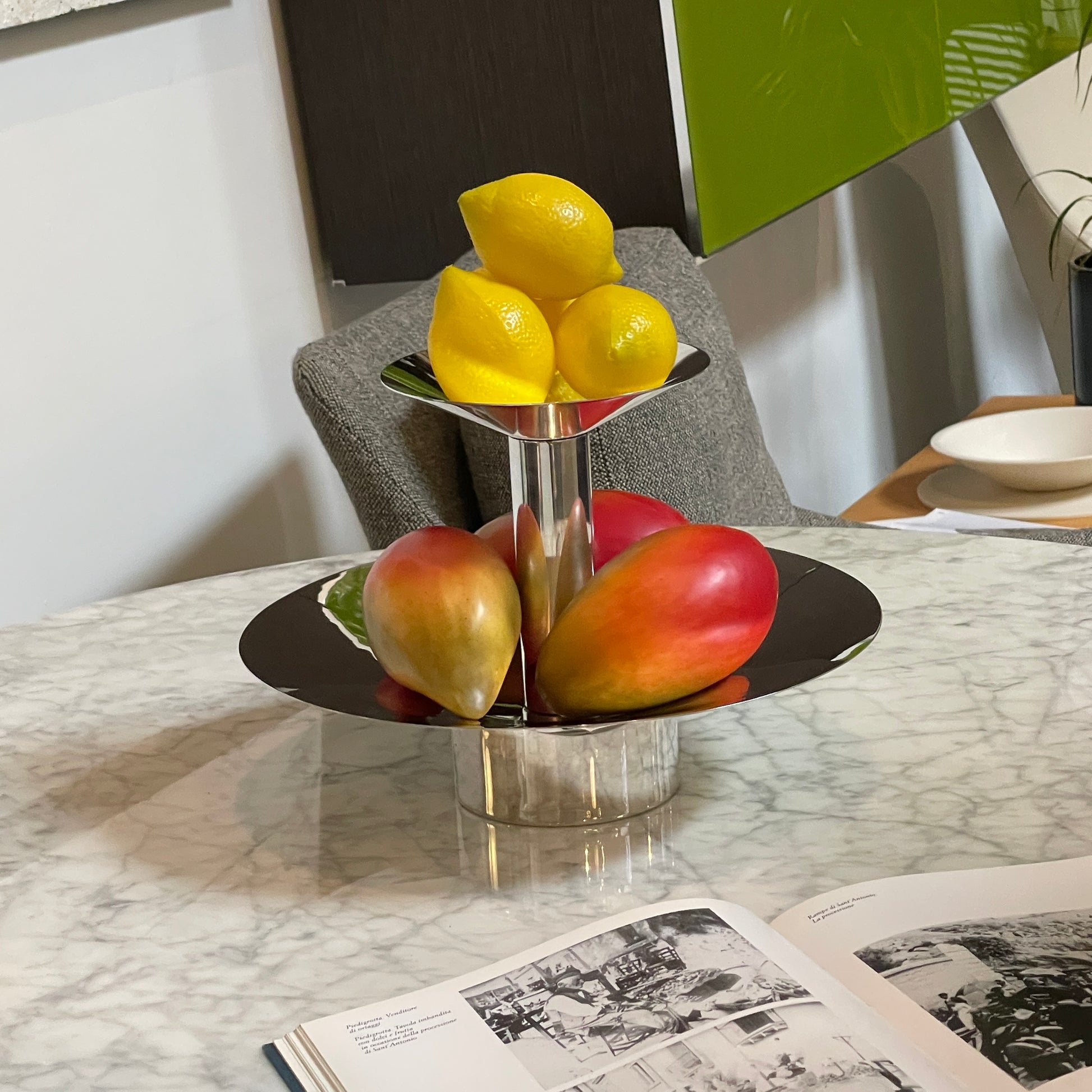 An Enzo Mari-inspired, tiered metal Driade Silver Fruit Stand Centerpiece with a reflective silver finish, isolated on a white background.