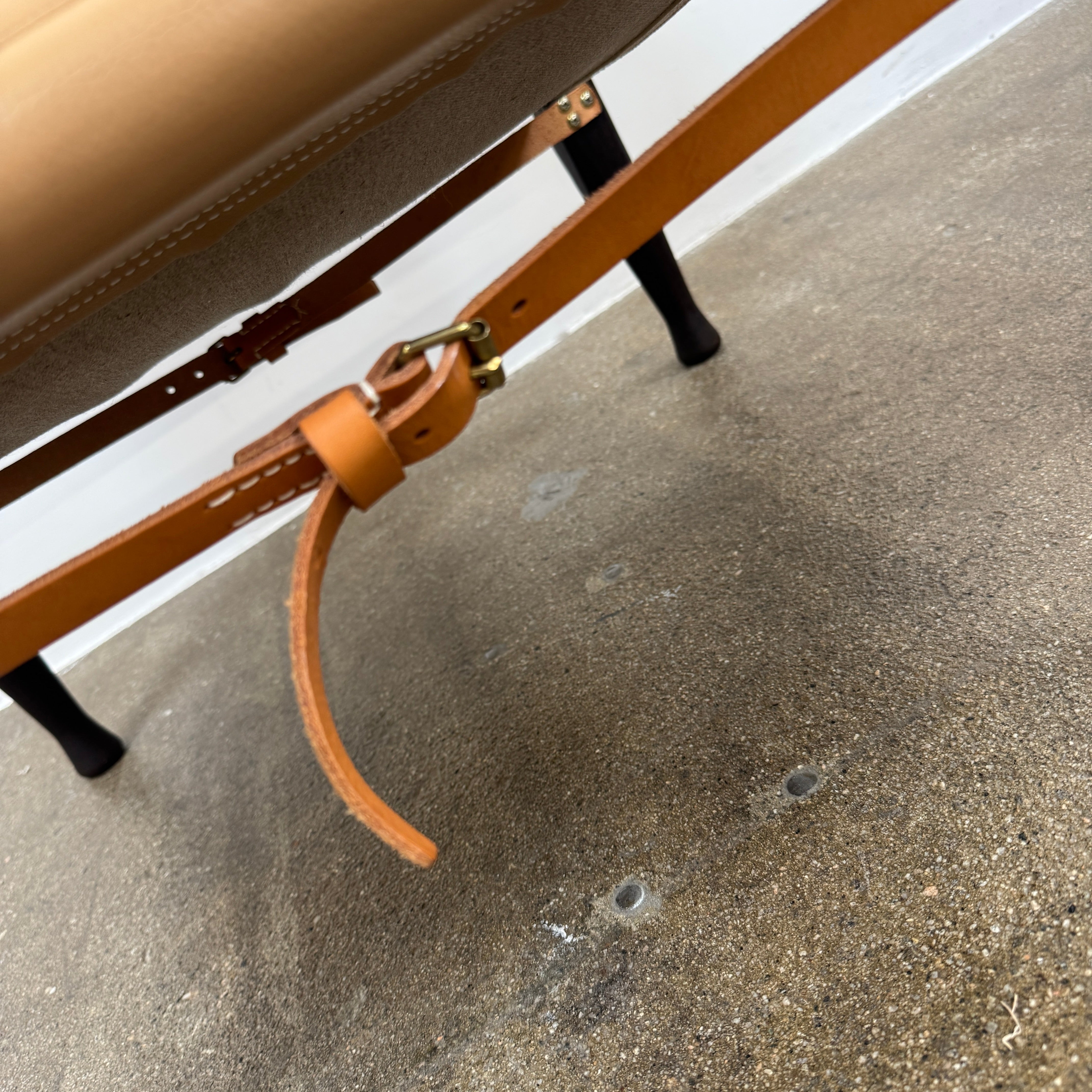 The Carl Hansen & Son KK47000 Safari Lounge Chair by Kaare Klint features canvas and leather with wooden legs and armrests, shown from the front on a plain white background.