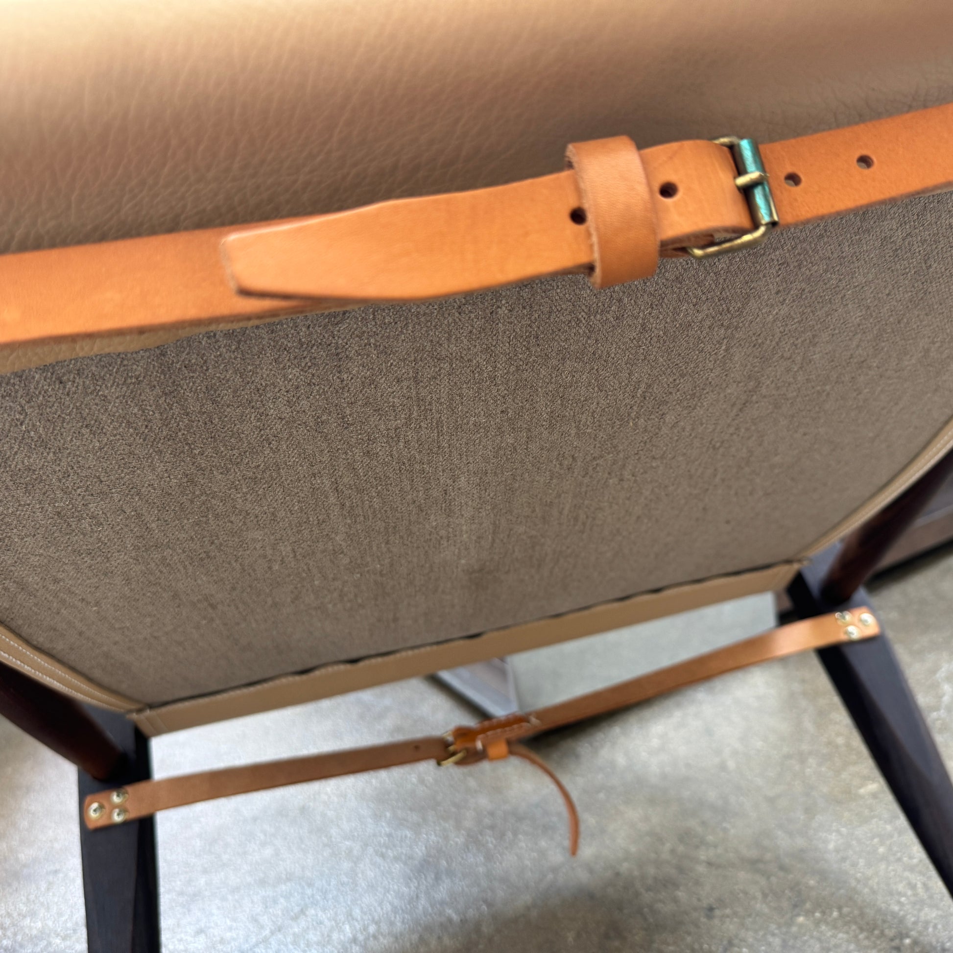 The Carl Hansen & Son KK47000 Safari Lounge Chair by Kaare Klint features canvas and leather with wooden legs and armrests, shown from the front on a plain white background.