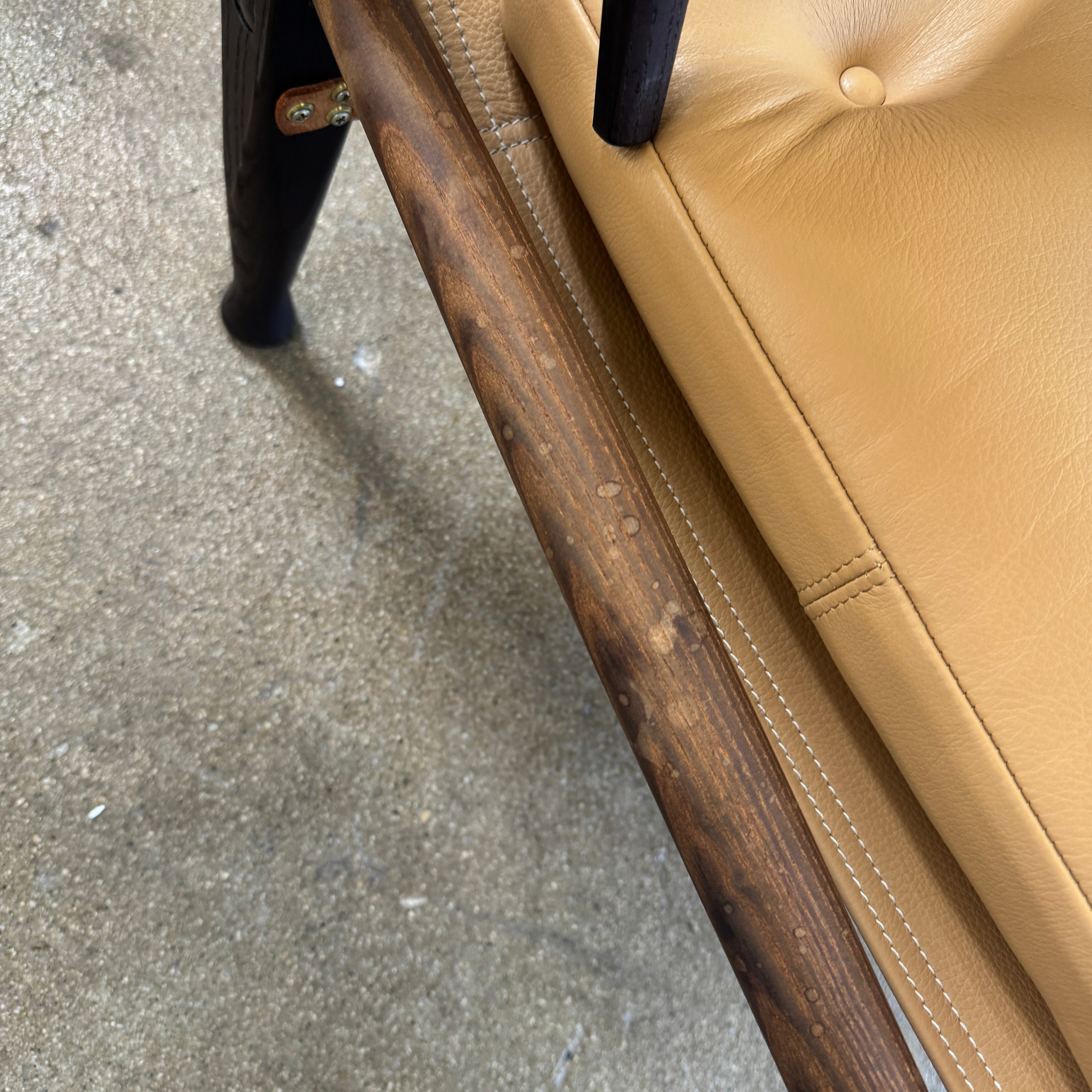 The Carl Hansen & Son KK47000 Safari Lounge Chair by Kaare Klint features canvas and leather with wooden legs and armrests, shown from the front on a plain white background.