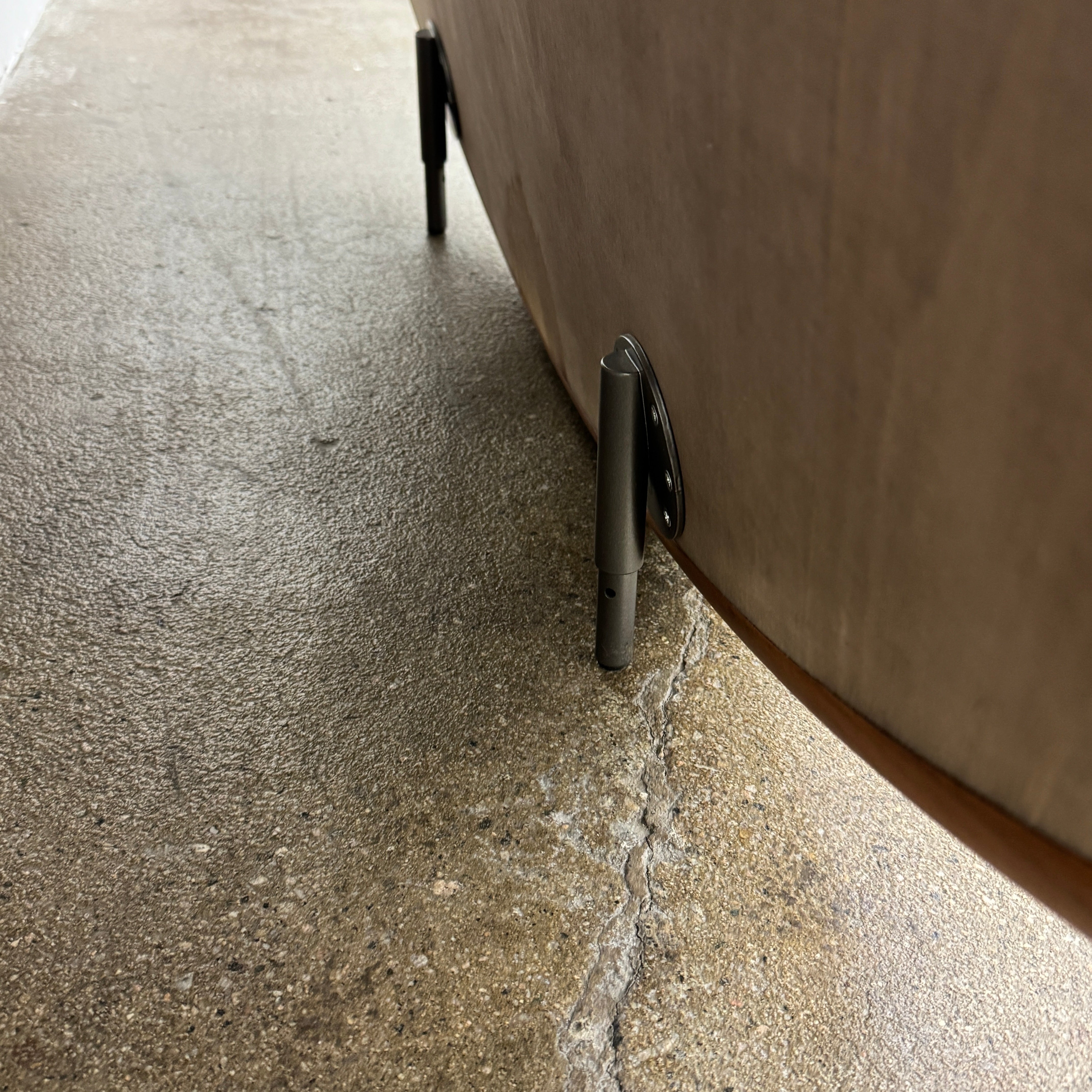The Porada Giove Mirror with Canaletta Walnut Frame by Porada leans against the wall, beautifully reflecting a modern space and serving as an eye-catching floor mirror centerpiece.