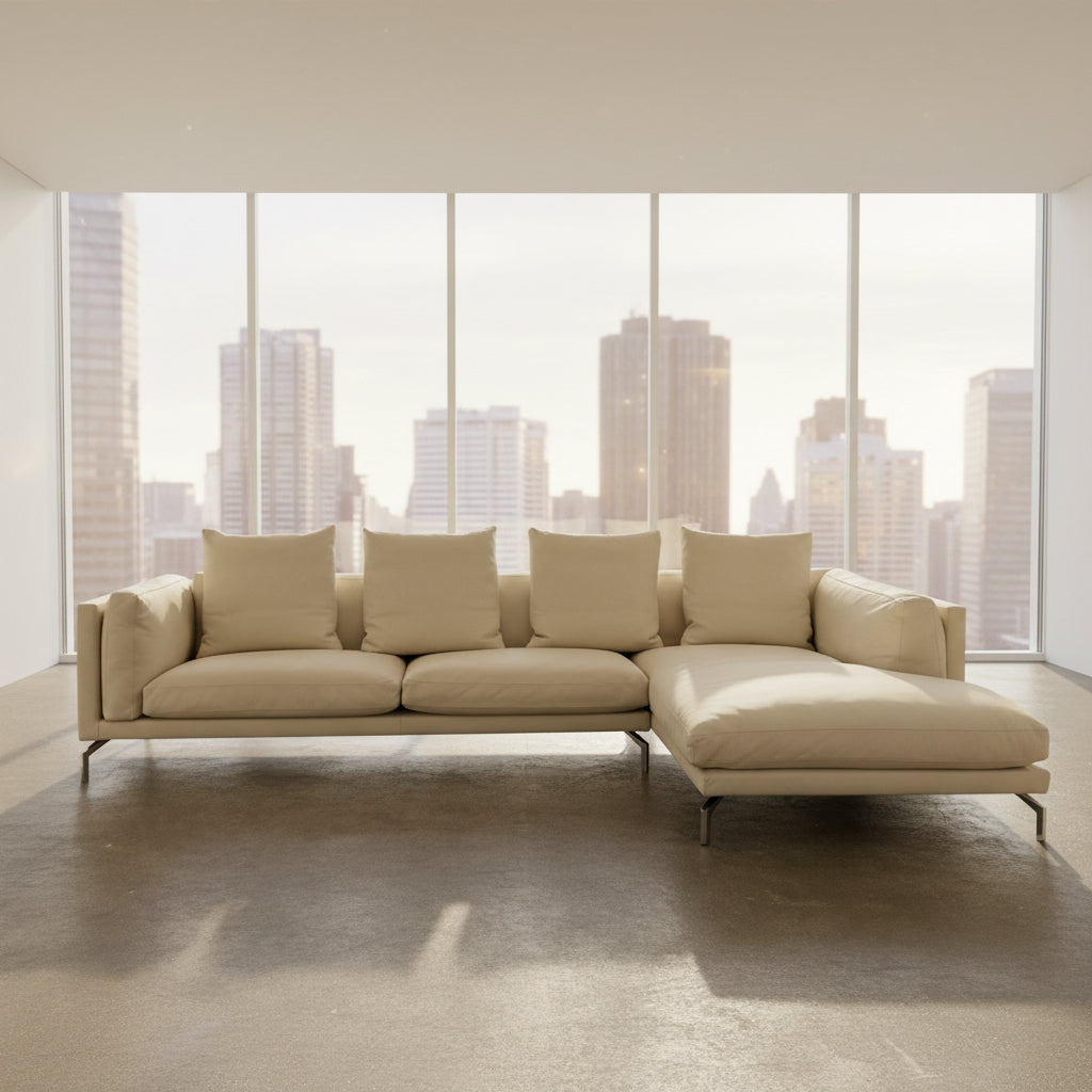 The DWR Como Sectional Sofa by DWR, in beige, features five back cushions and metal legs, showcasing Italian designer inspiration against a white background.