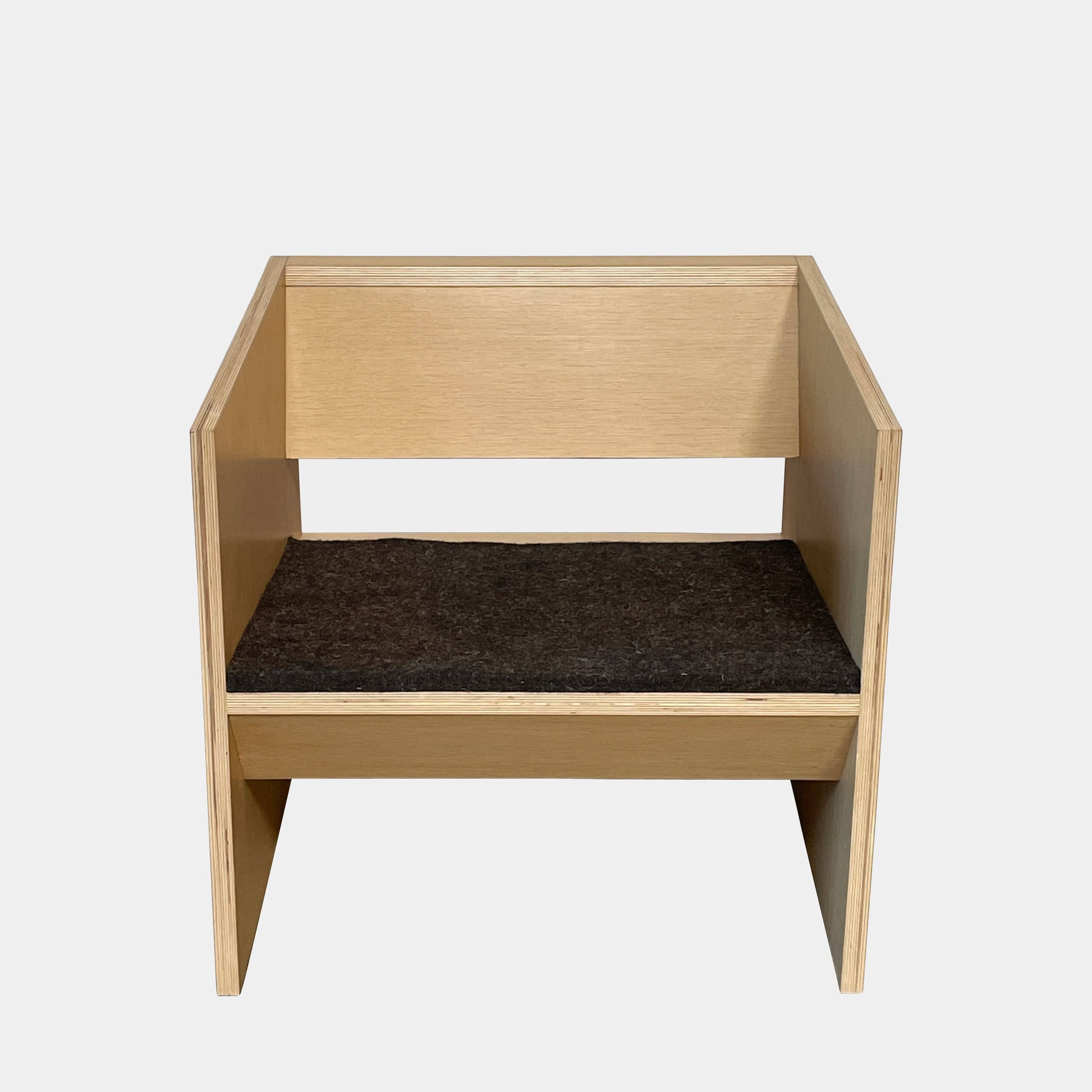 A NorCal Lounge Chair by Chris Baisa with a black cushion.