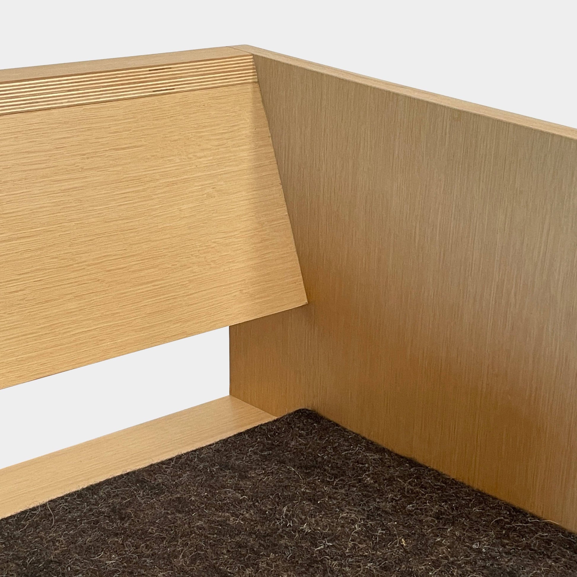 A NorCal Lounge Chair by Chris Baisa with a black cushion.