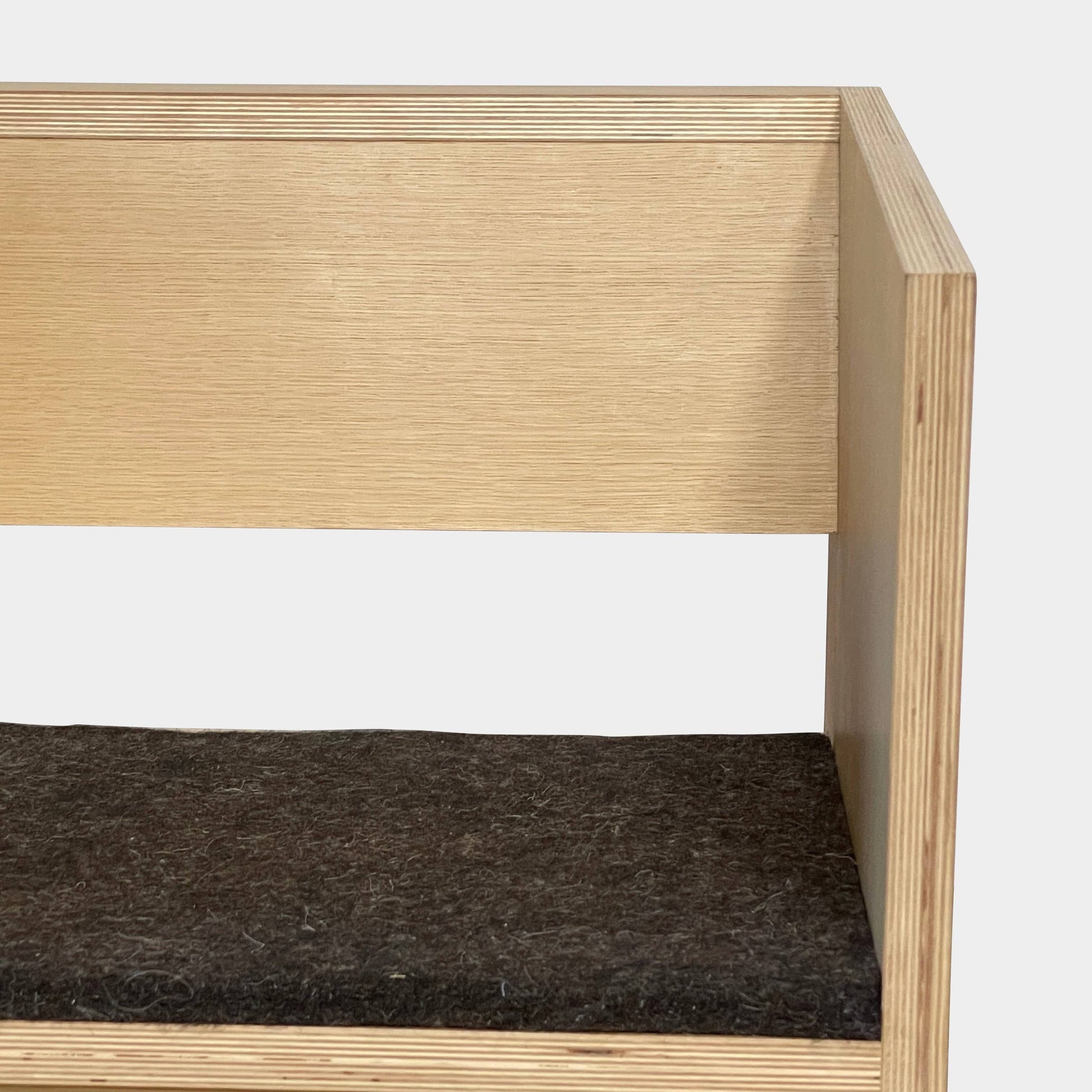 A NorCal Lounge Chair by Chris Baisa with a black cushion.