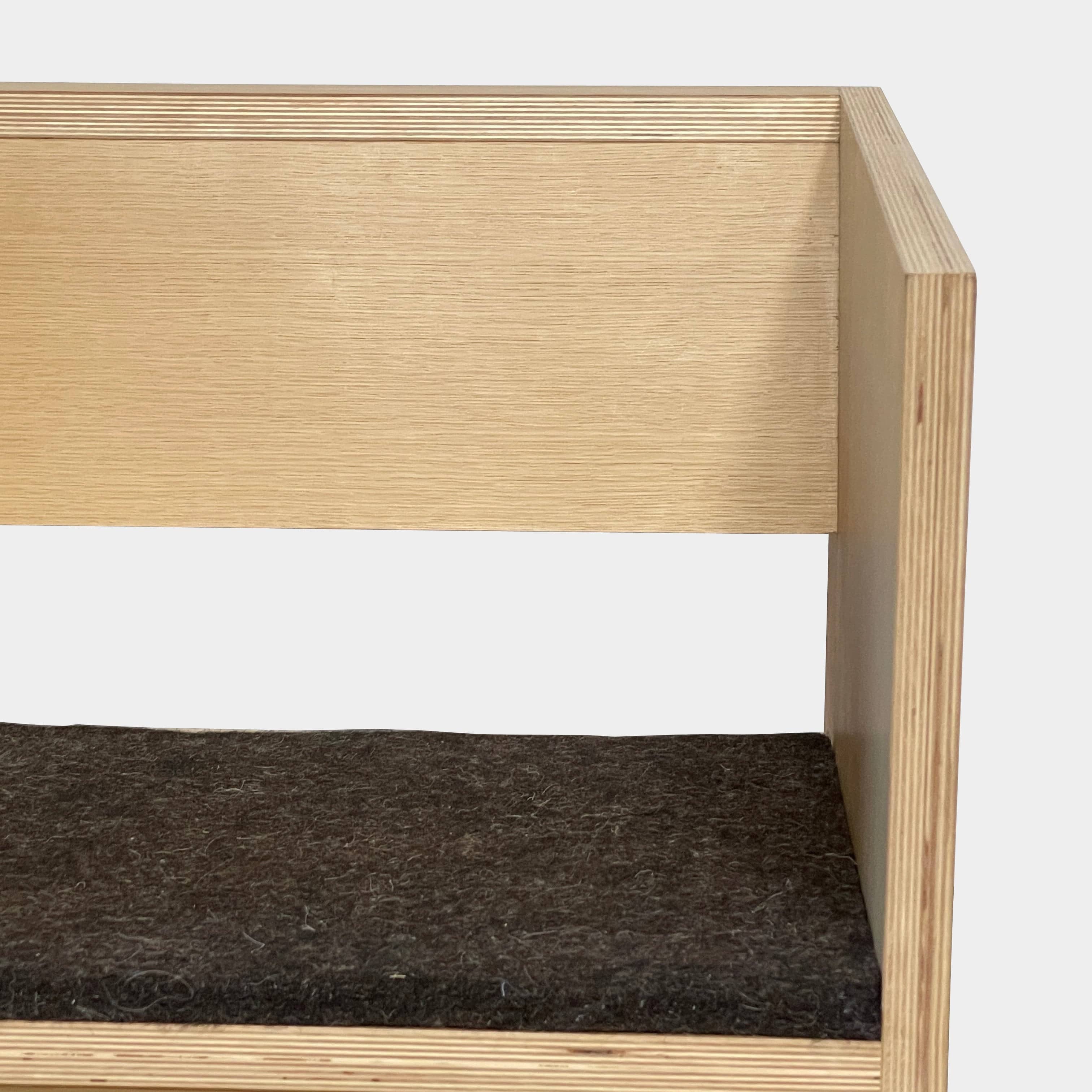 A NorCal Lounge Chair by Chris Baisa with a black cushion.