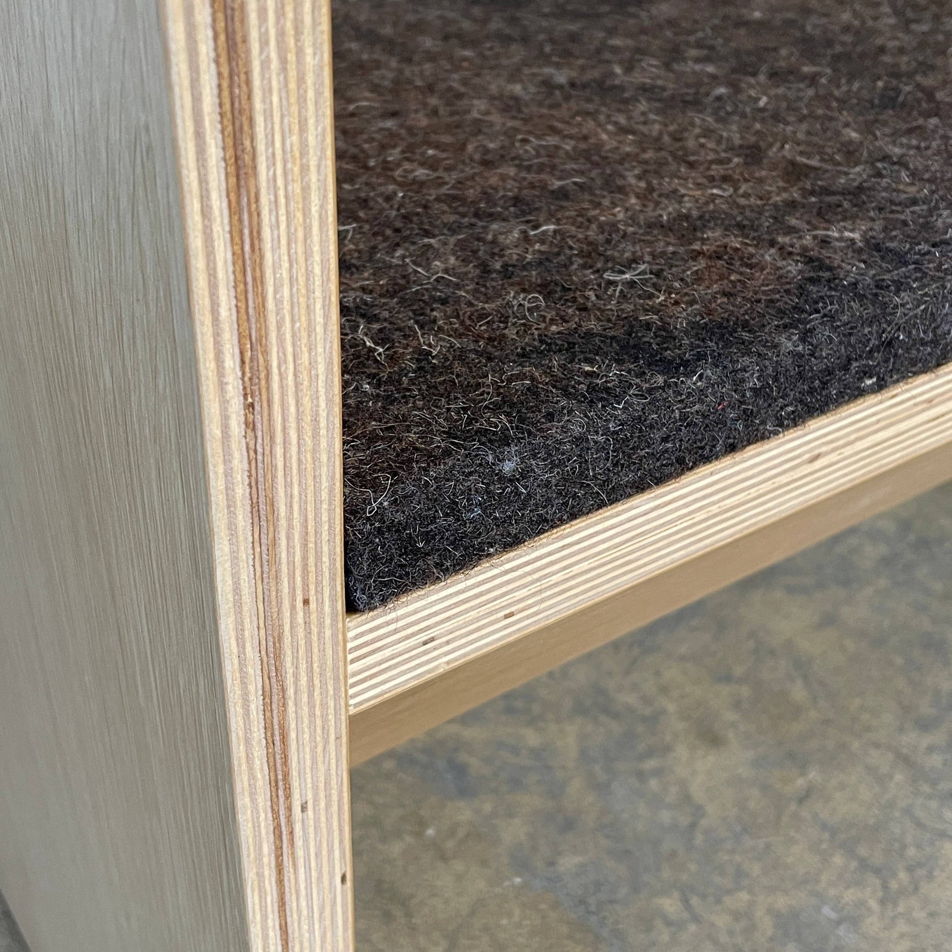 A NorCal Lounge Chair by Chris Baisa with a black cushion.