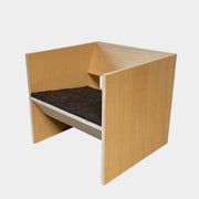 A NorCal Lounge Chair by Chris Baisa with a black cushion.