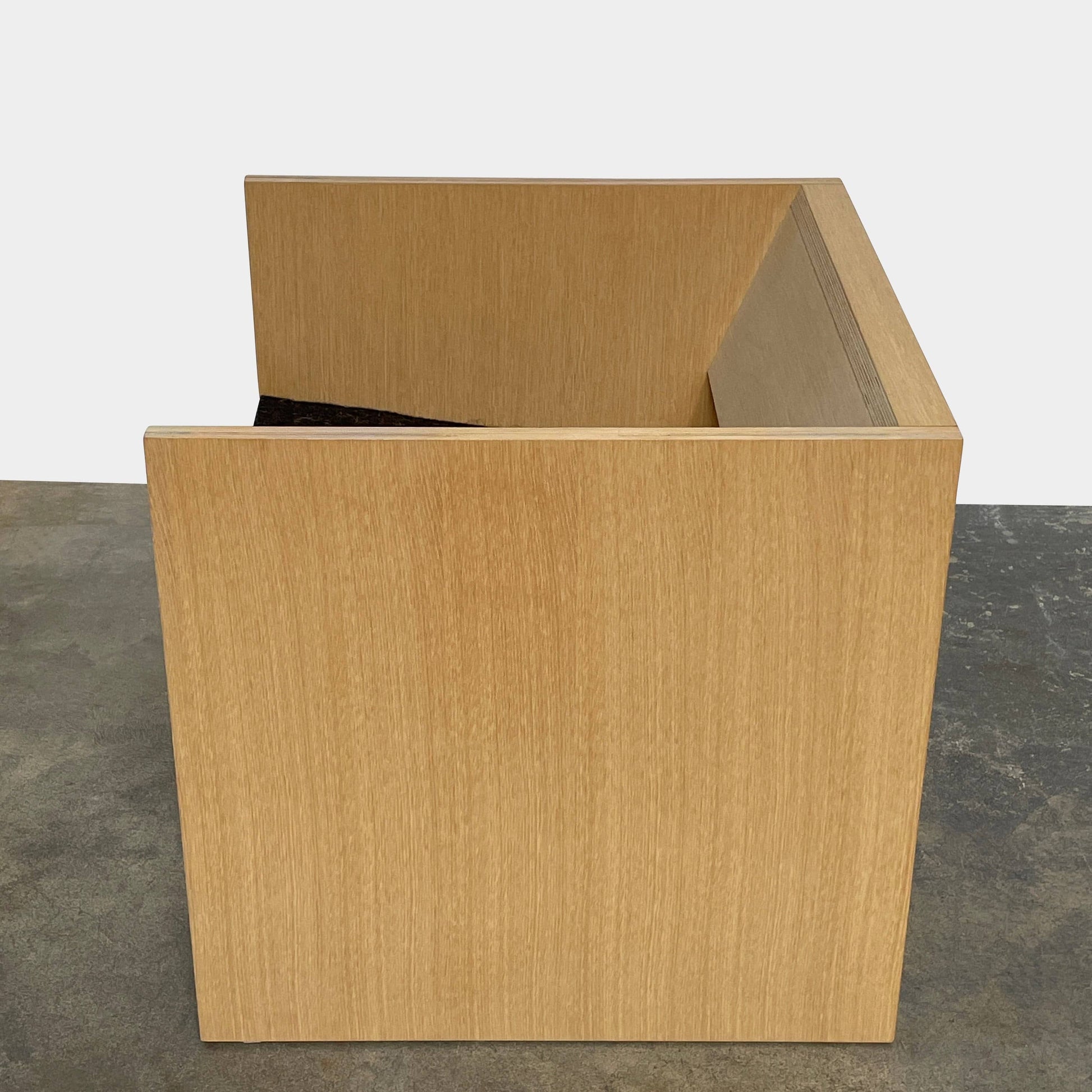 A NorCal Lounge Chair by Chris Baisa with a black cushion.