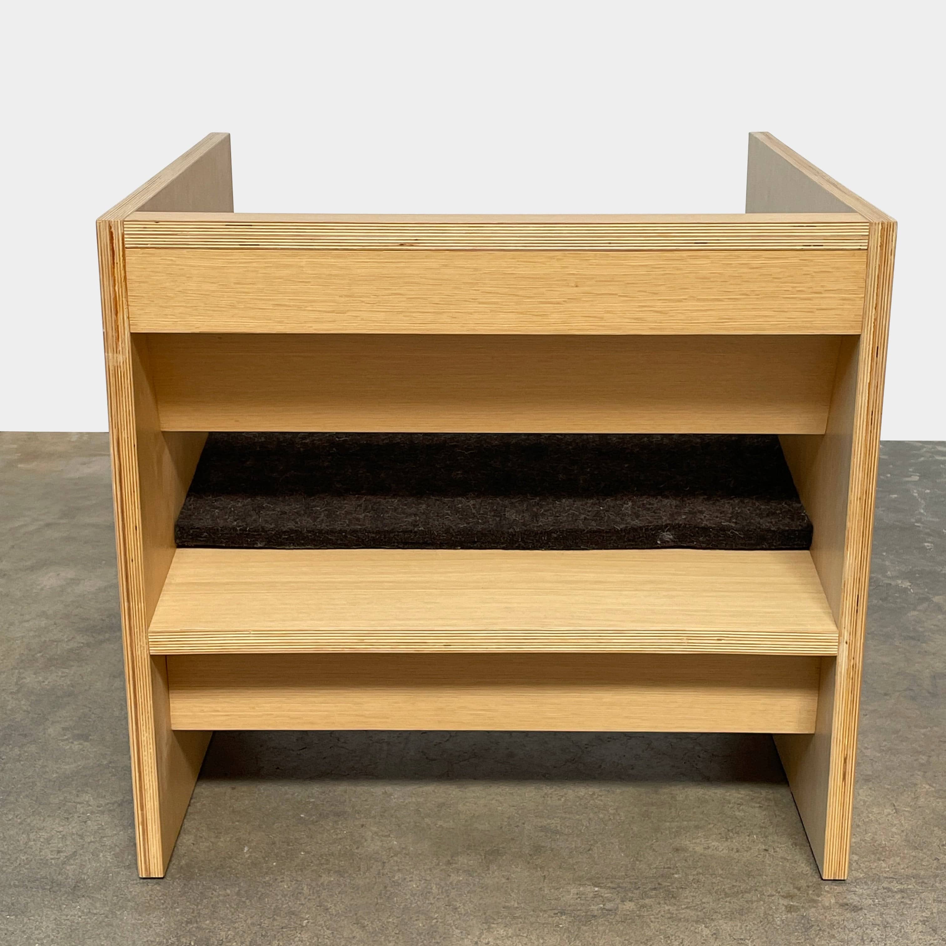 A NorCal Lounge Chair by Chris Baisa with a black cushion.