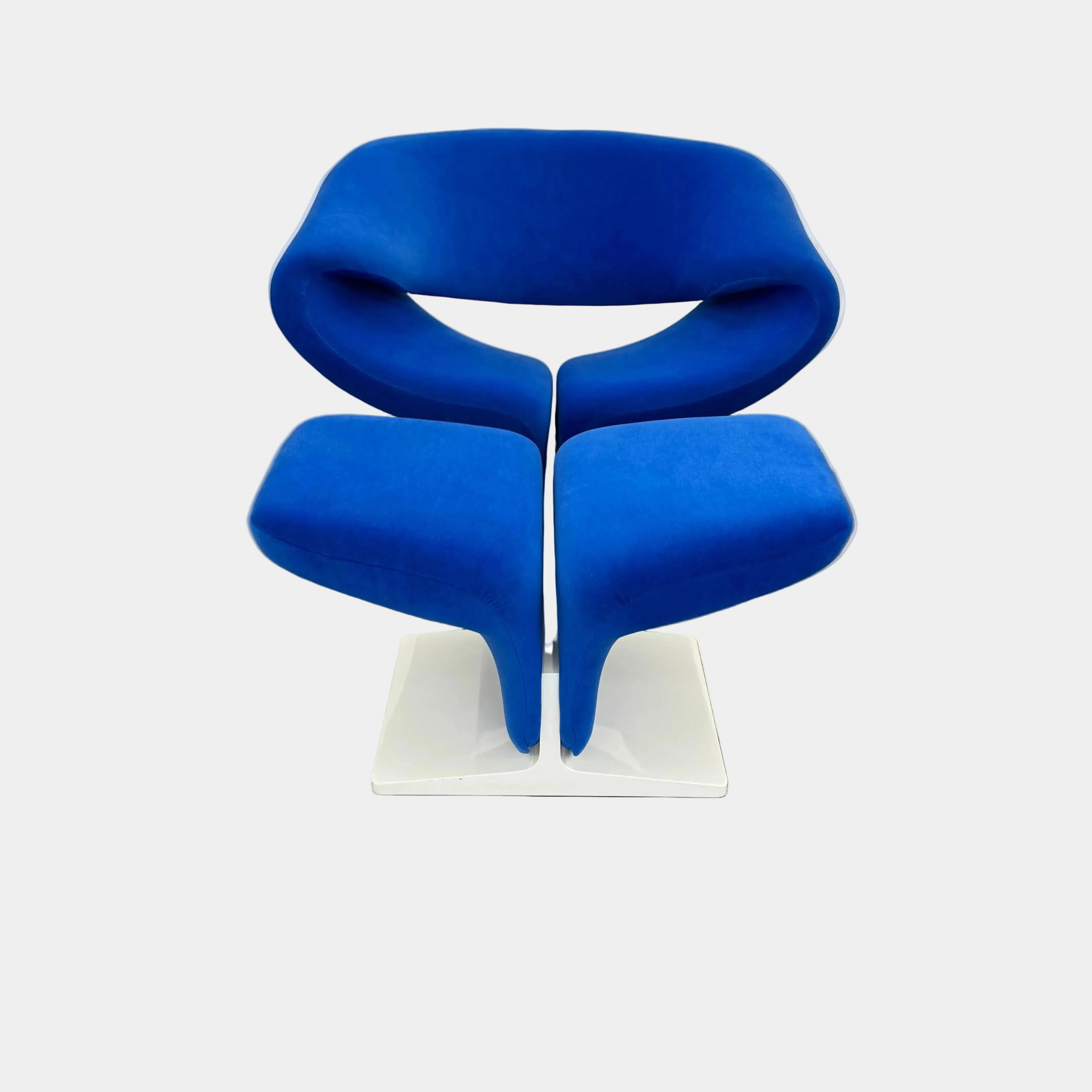 The Artifort Ribbon Lounge Chair & Ottoman by Artifort features a modern blue design with a sculptural curved backrest and split seat on a white base, seen here against a plain white background.