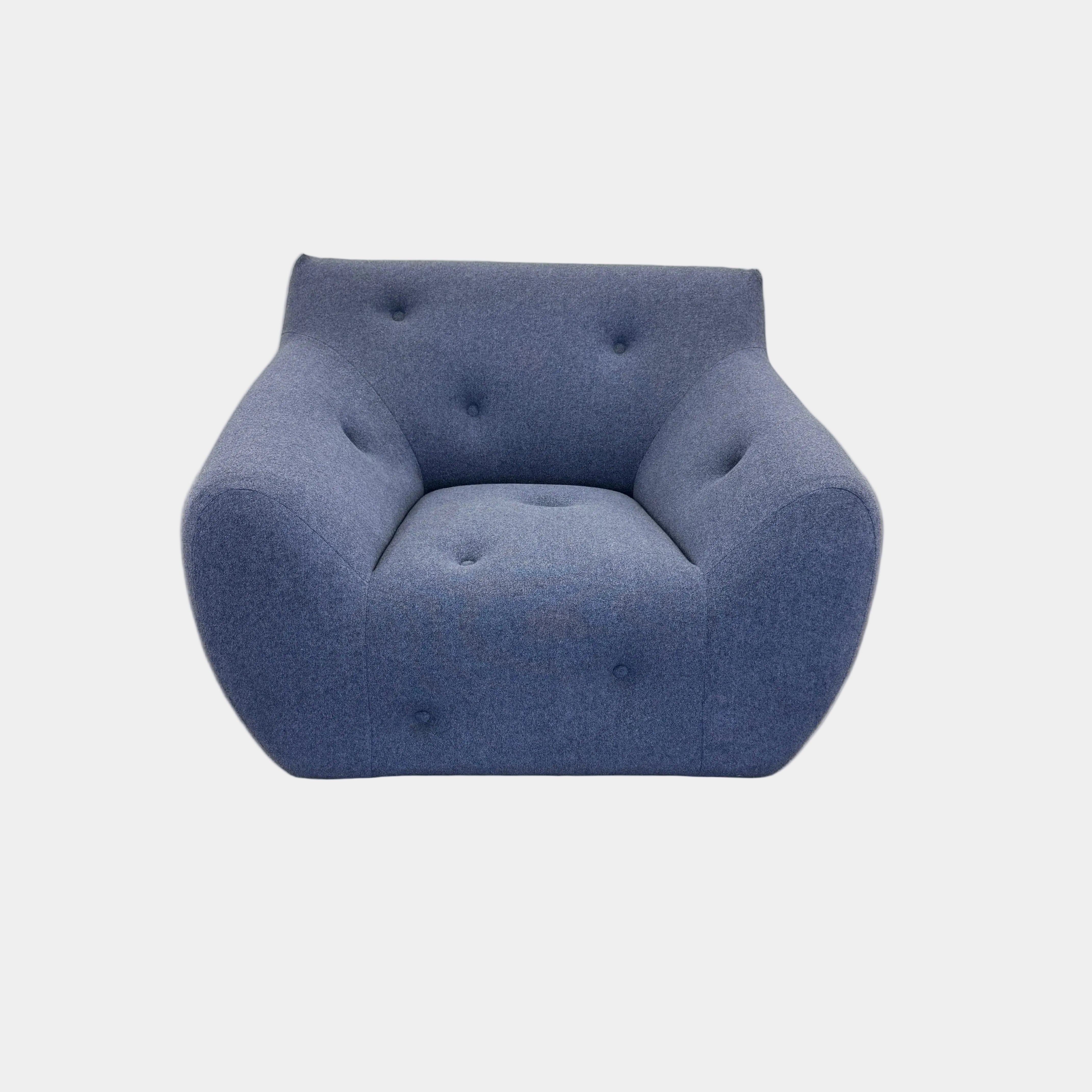 The Roche Bobois Informel Outdoor Armchair Low Back - Bleuet is a modern blue armchair with tufted buttons and plush comfort, shown against a white background.