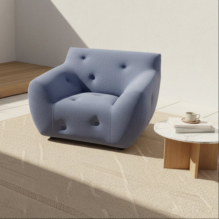 The Roche Bobois Informel Outdoor Armchair Low Back - Bleuet is a modern blue armchair with tufted buttons and plush comfort, shown against a white background.