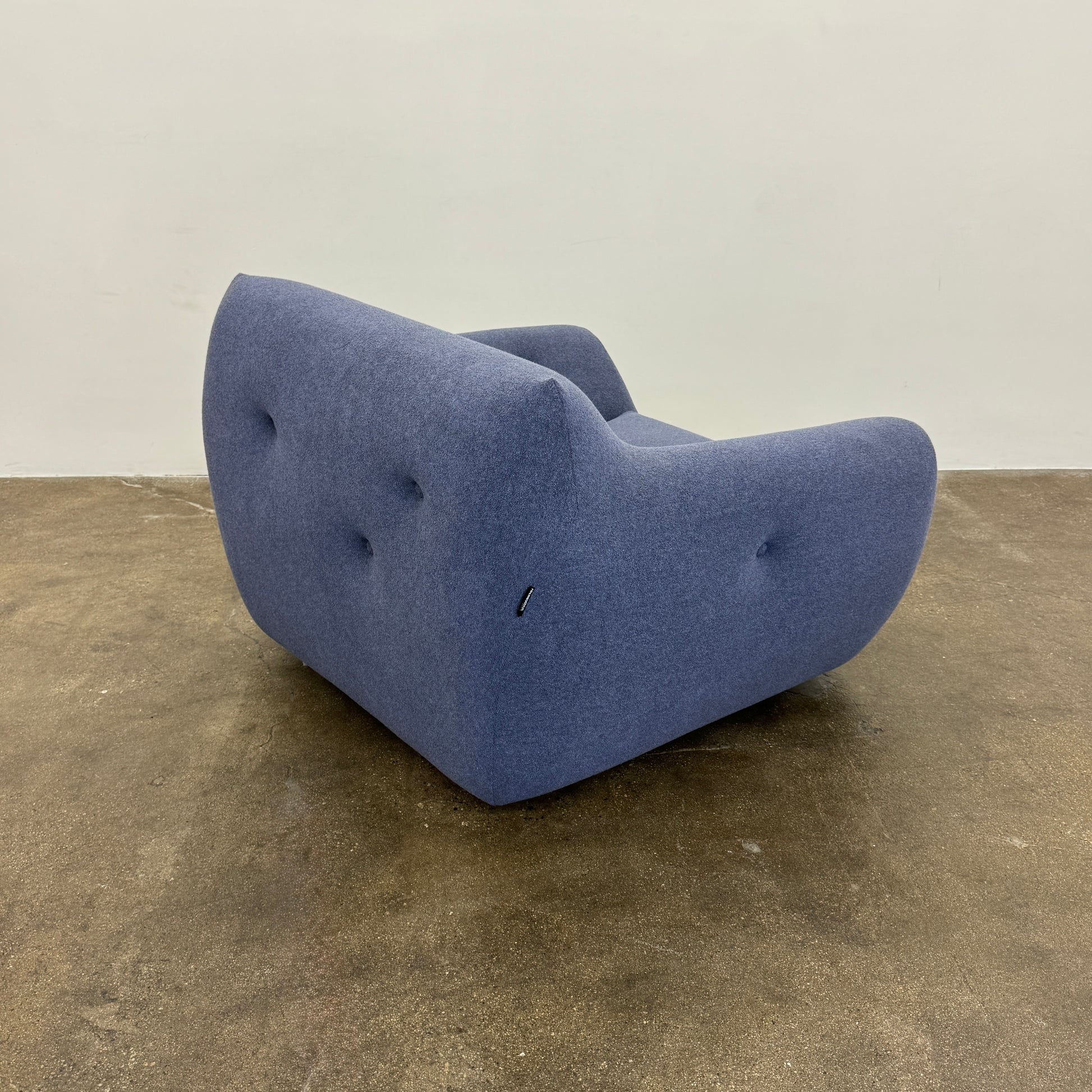 The Roche Bobois Informel Outdoor Armchair Low Back - Bleuet is a modern blue armchair with tufted buttons and plush comfort, shown against a white background.