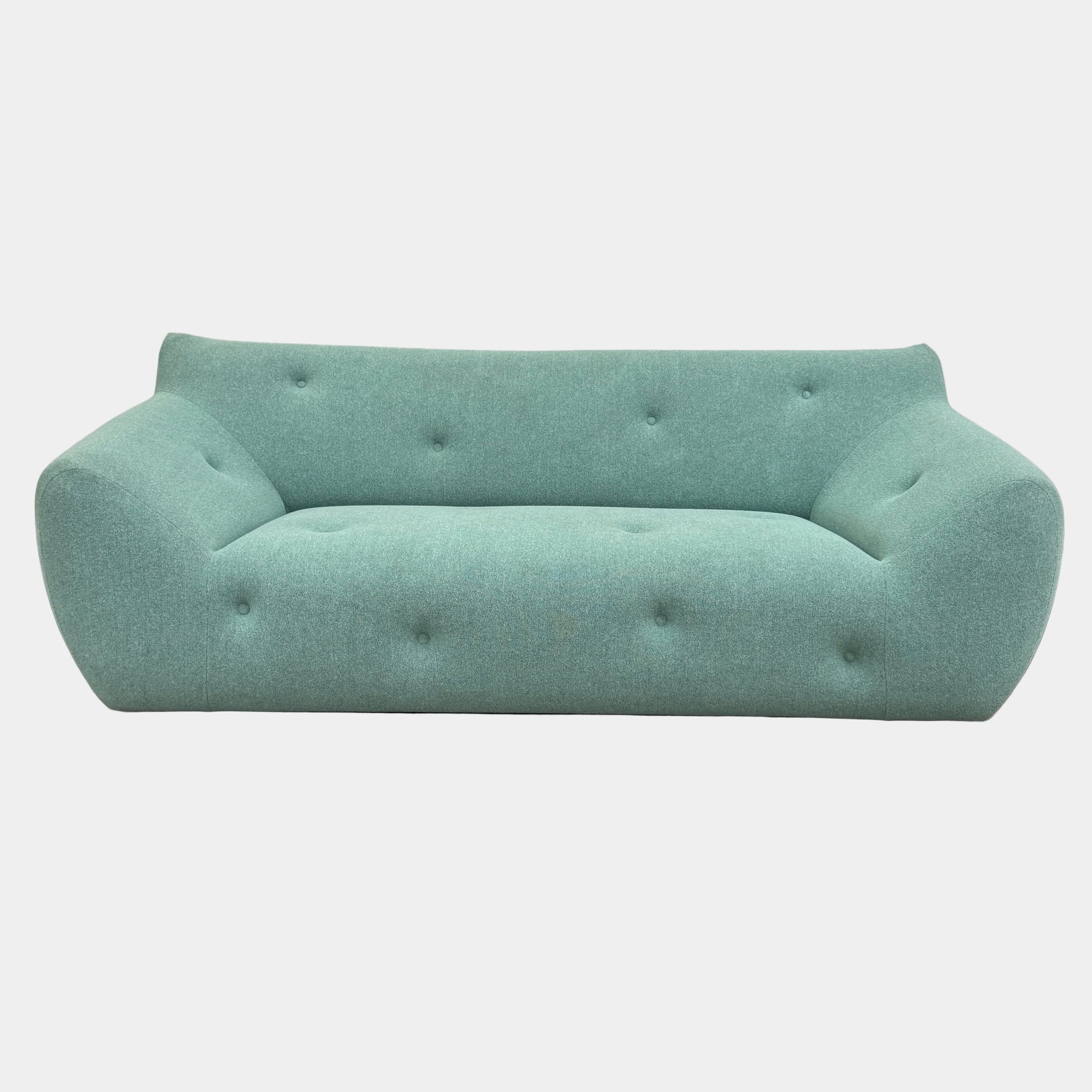 The Roche Bobois Informel Outdoor Large 3-seat Sofa Low Back features a light teal modern design with rounded edges, button-tufted details, and advanced outdoor fabric technology, inspired by Roche Bobois’s signature style.