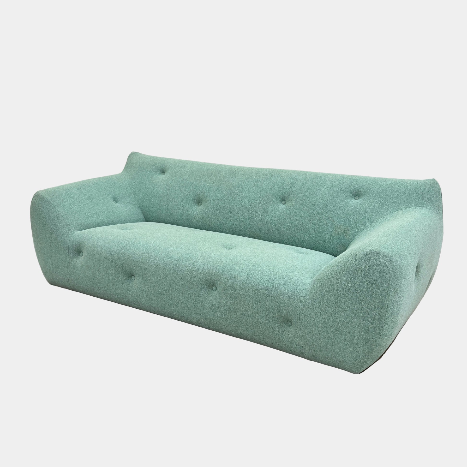 The Roche Bobois Informel Outdoor Large 3-seat Sofa Low Back features a light teal modern design with rounded edges, button-tufted details, and advanced outdoor fabric technology, inspired by Roche Bobois’s signature style.
