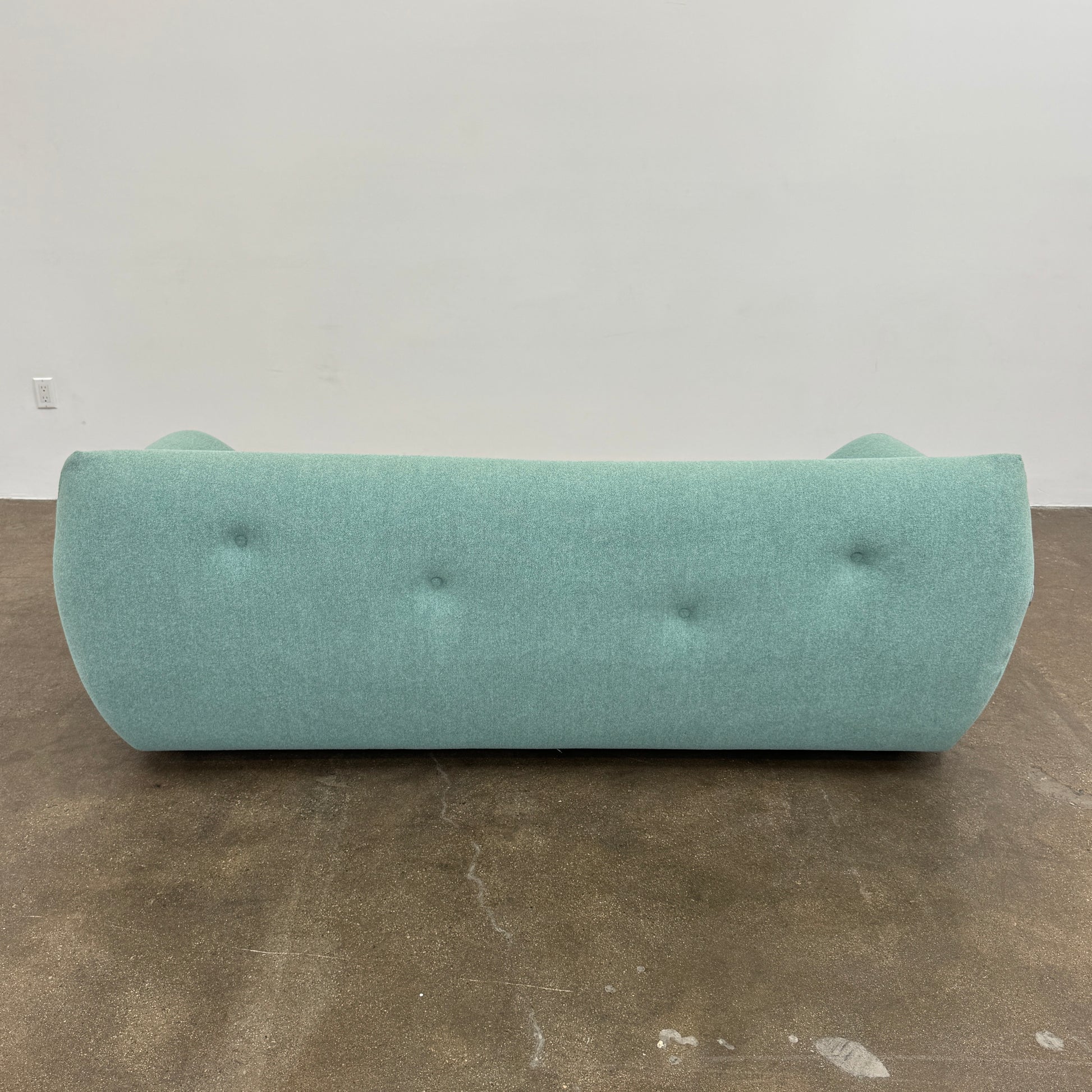 The Roche Bobois Informel Outdoor Large 3-seat Sofa Low Back features a light teal modern design with rounded edges, button-tufted details, and advanced outdoor fabric technology, inspired by Roche Bobois’s signature style.
