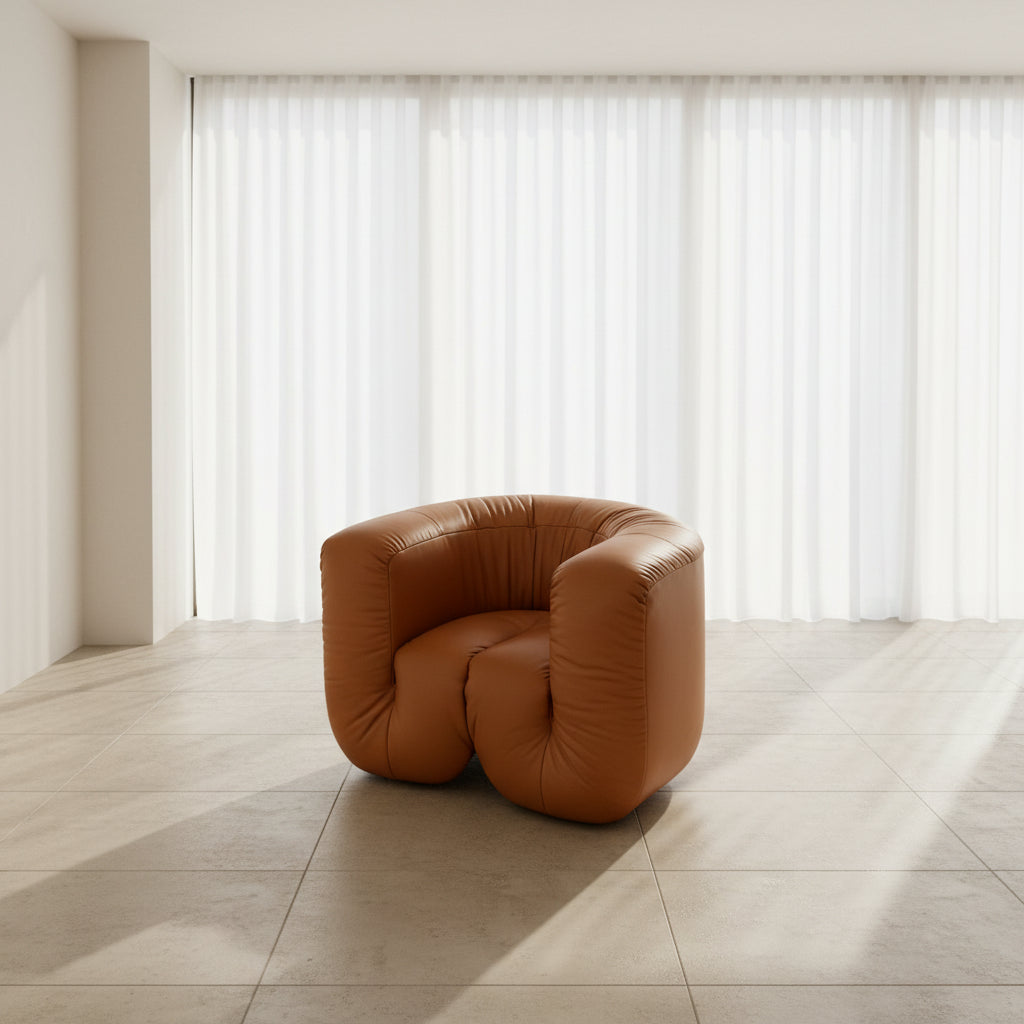 The De Sede DS-707 Canada Armchair by De Sede features rounded arms, light brown leather with deep creases, and a low, wide seat, shown against a plain white background.