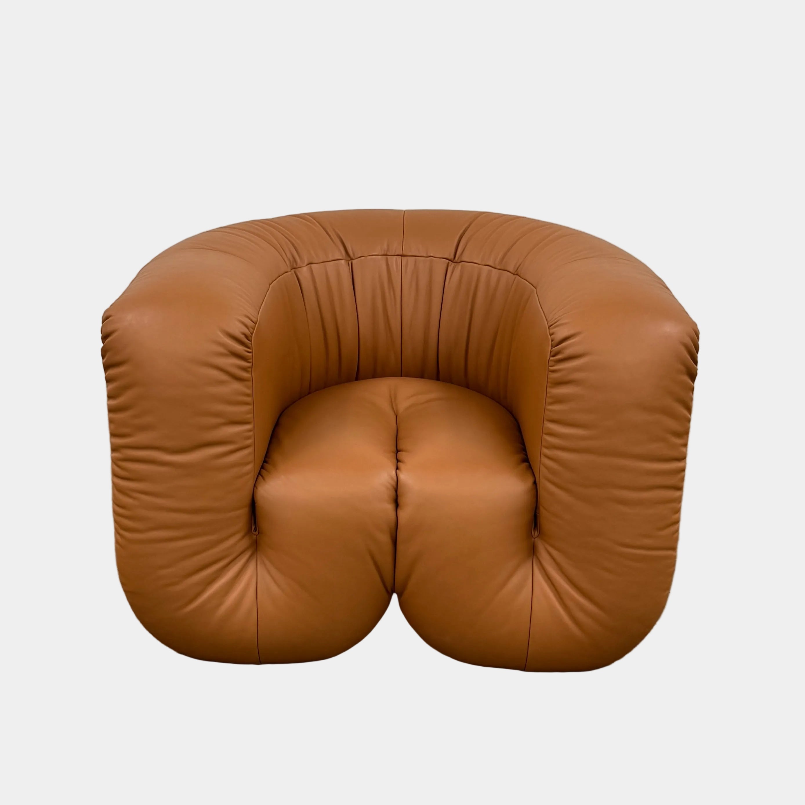 The De Sede DS-707 Canada Armchair by De Sede features rounded arms, light brown leather with deep creases, and a low, wide seat, shown against a plain white background.