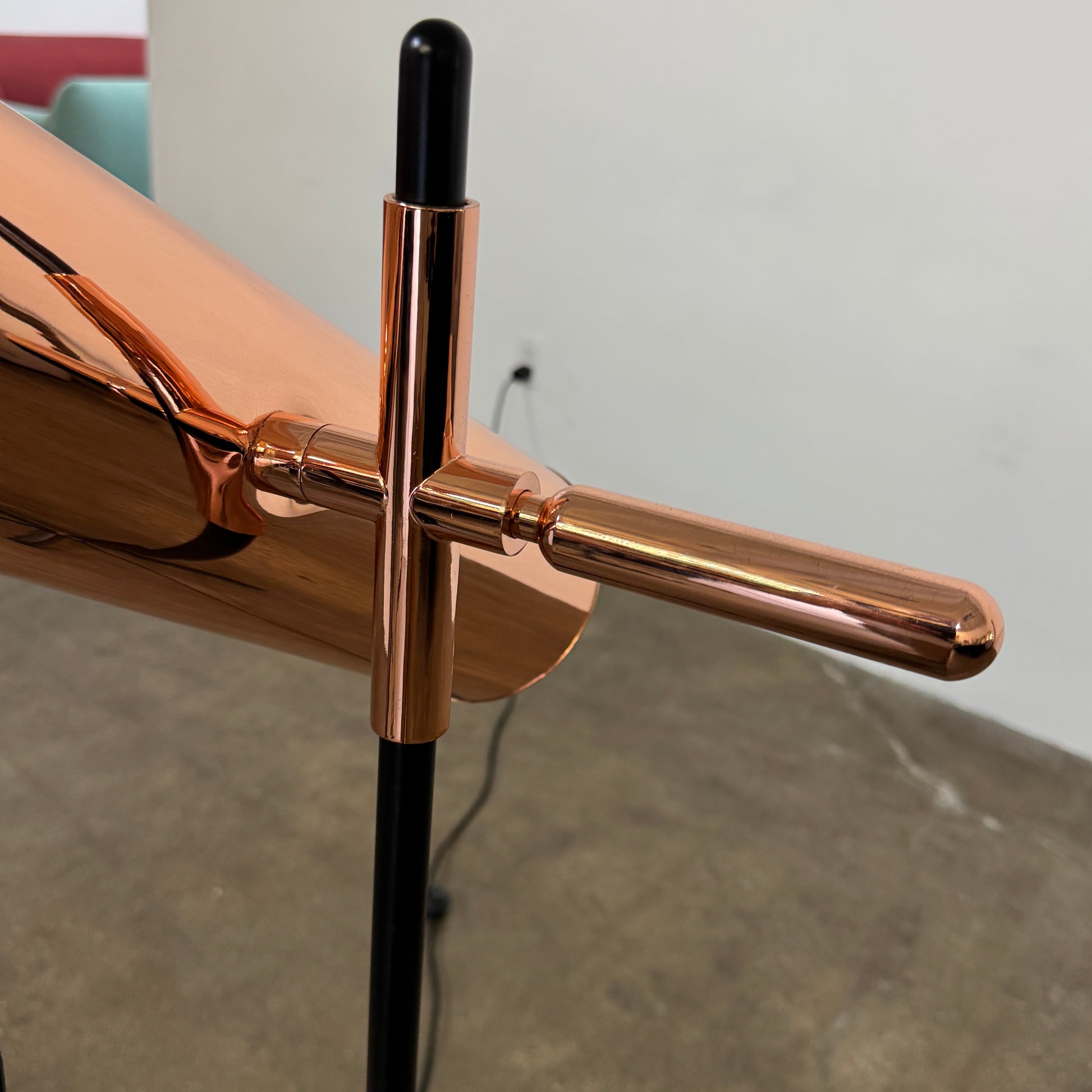 The Roche Bobois Wander Floor lamp features a cylindrical copper shade, black stand, and tripod base with attached power cord—an elegant, modern addition inspired by Roche Bobois design.