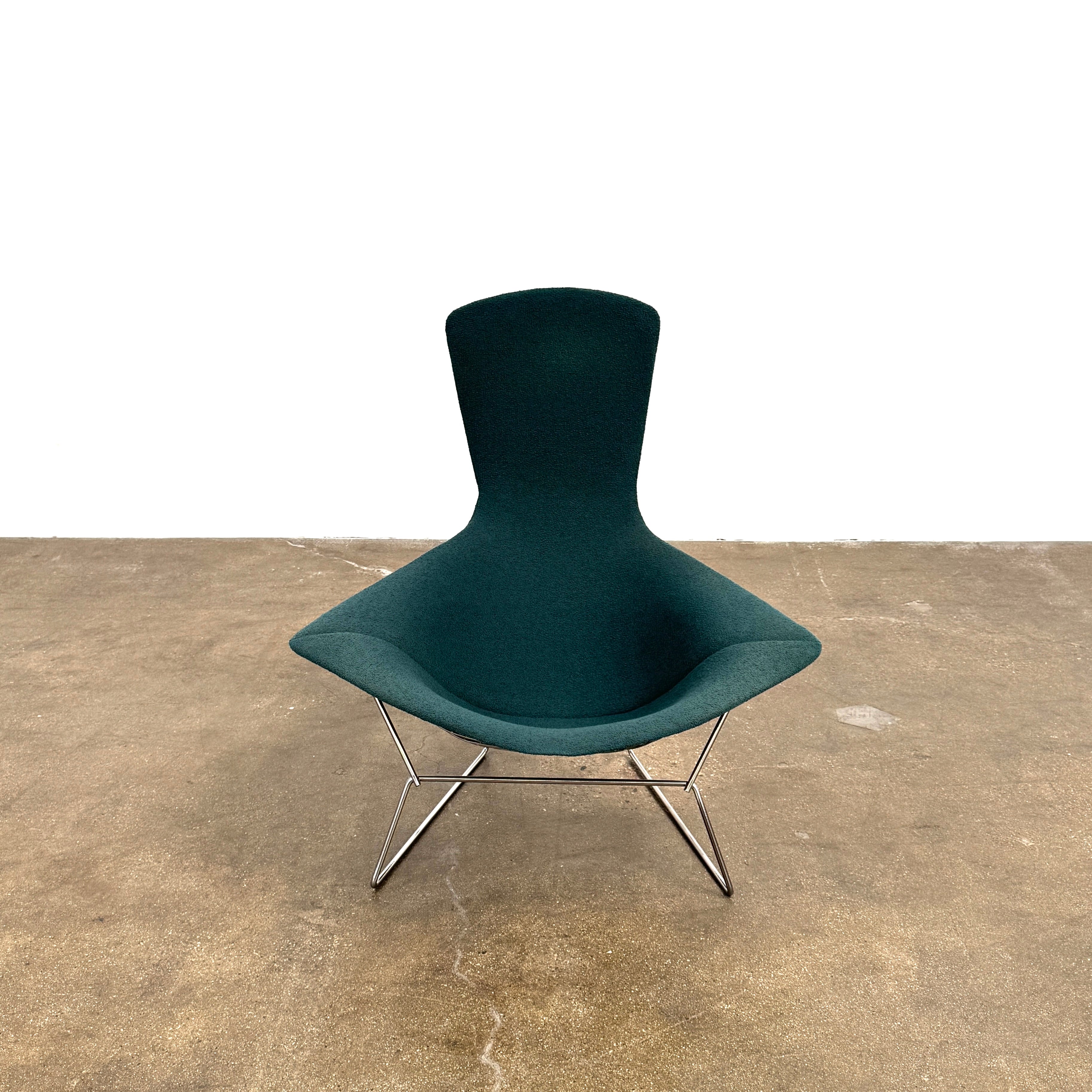 The Vintage Bertoia Bird Chair by Vintage features a modern green upholstered design with a curved backrest and metal wire base, inspired by mid-century style, photographed against a plain white background.