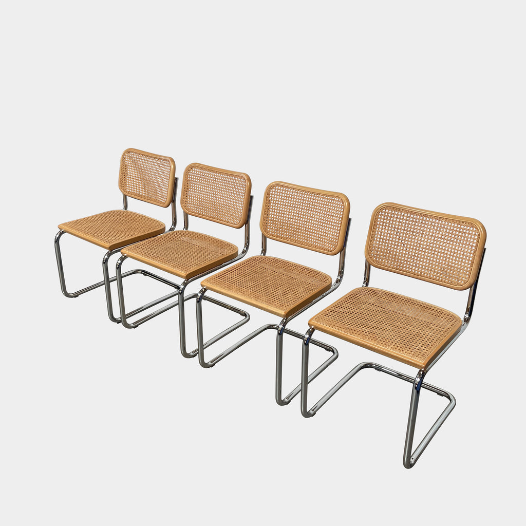 Four Knoll Cesca Dining Chairs with wicker seating and backrests, lined up side by side against a white background.