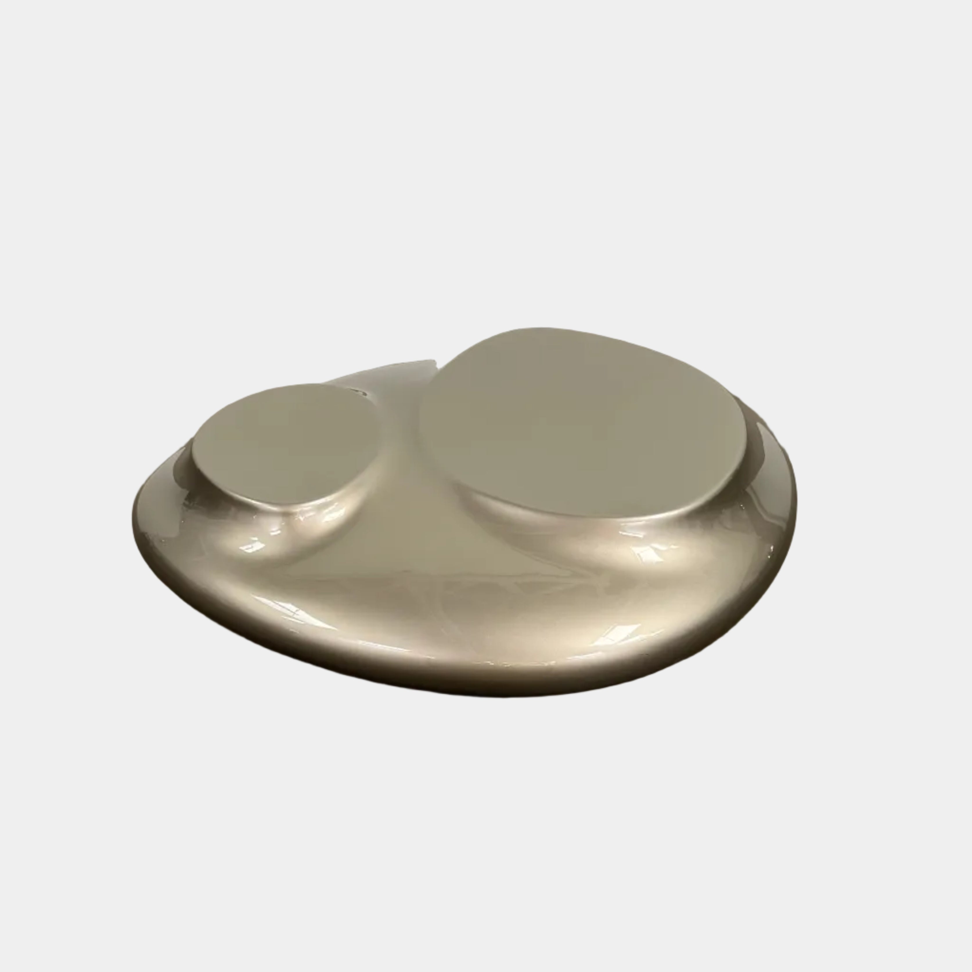 A metallic, smooth, irregularly shaped object with three raised sections on a white background—evoking the sleek Roche Bobois Cute Cut | XXM Cocktail Table, ideal for modern interiors.