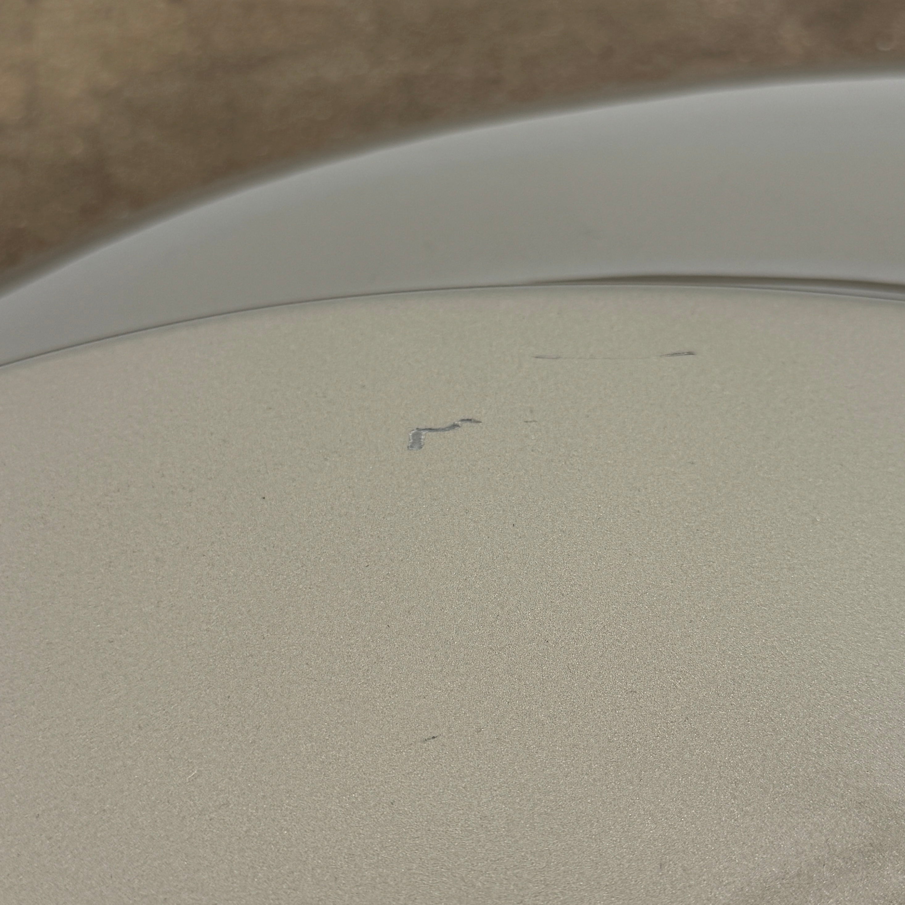 A metallic, smooth, irregularly shaped object with three raised sections on a white background—evoking the sleek Roche Bobois Cute Cut | XXM Cocktail Table, ideal for modern interiors.