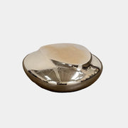 The Roche Bobois cute cut | XXS Cocktail table, with its round, reflective silver surface and smooth, unique shape, stands elegantly against a plain white background—an ideal accent for modern interiors.