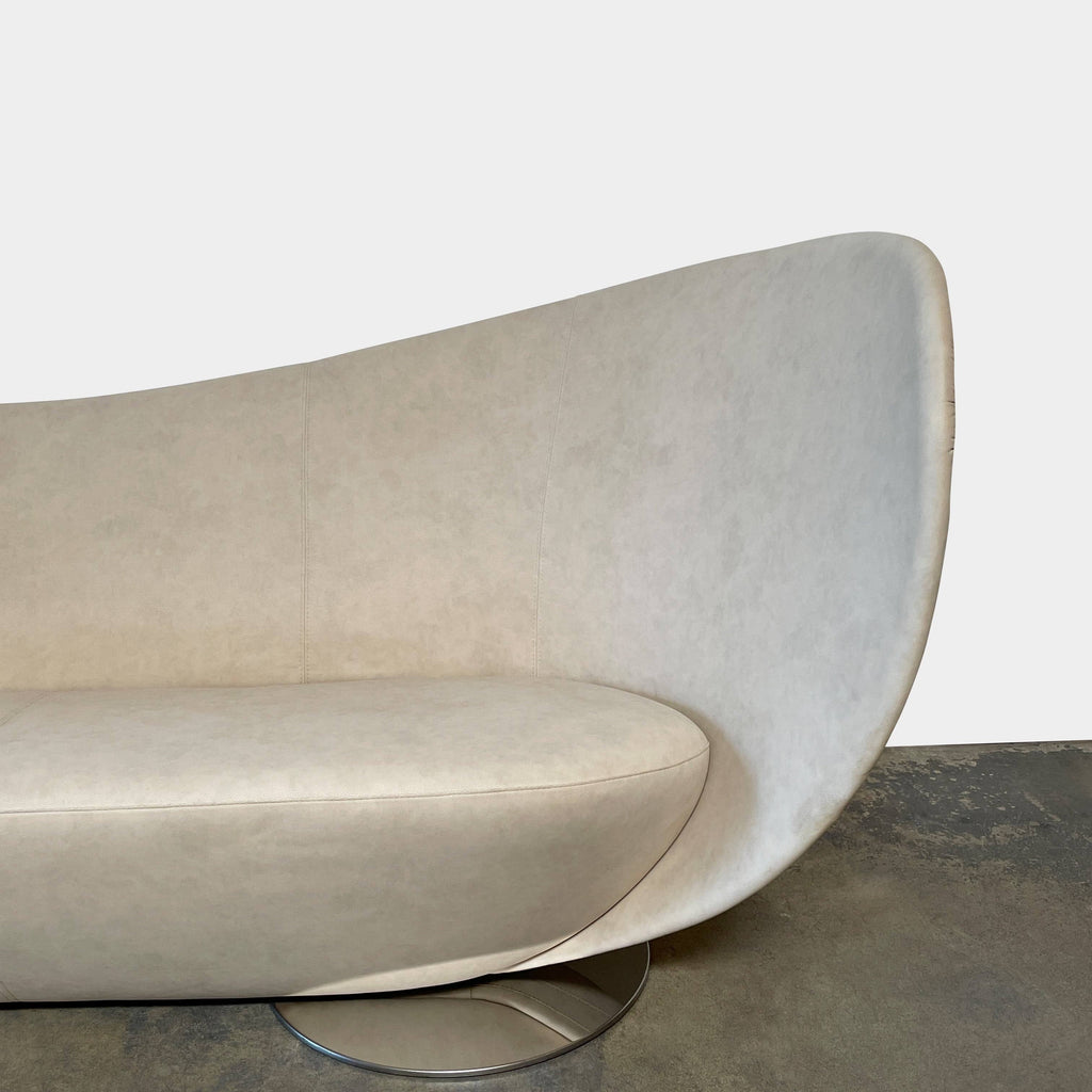 A modern beige La Cividina Mon Coeur Sofa with a curved backrest and metallic legs isolated on a white background.