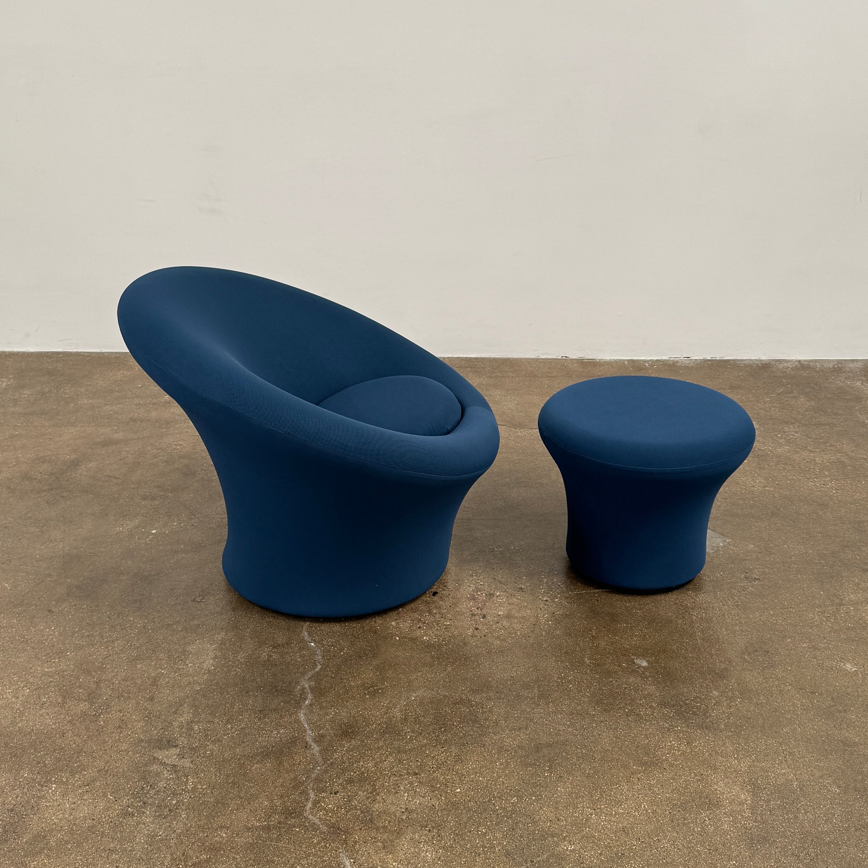 A modern blue Artifort Mushroom Chair & Ottoman by Artifort, featuring a rounded backrest and matching round ottoman, both displayed against a plain white background.