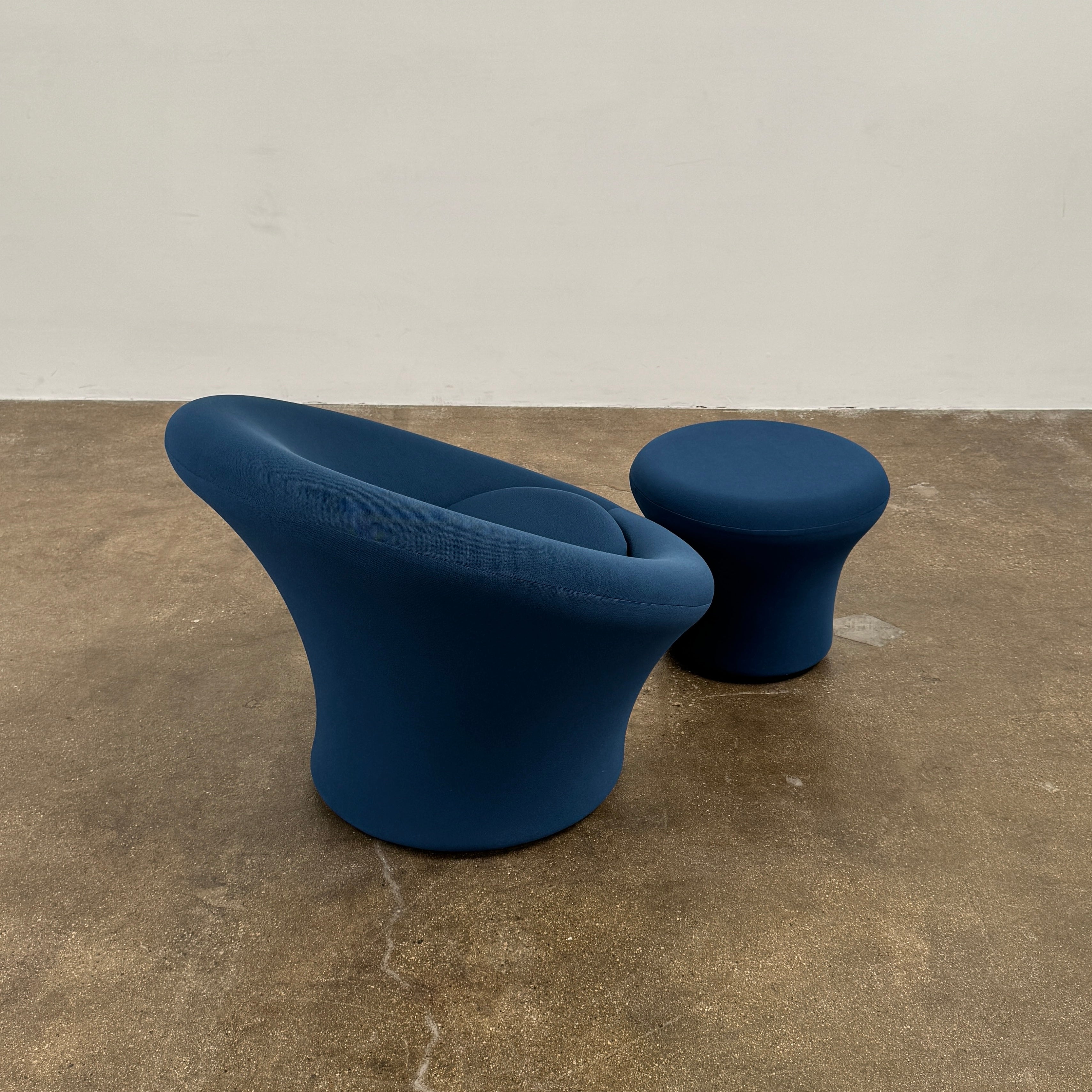 A modern blue Artifort Mushroom Chair & Ottoman by Artifort, featuring a rounded backrest and matching round ottoman, both displayed against a plain white background.