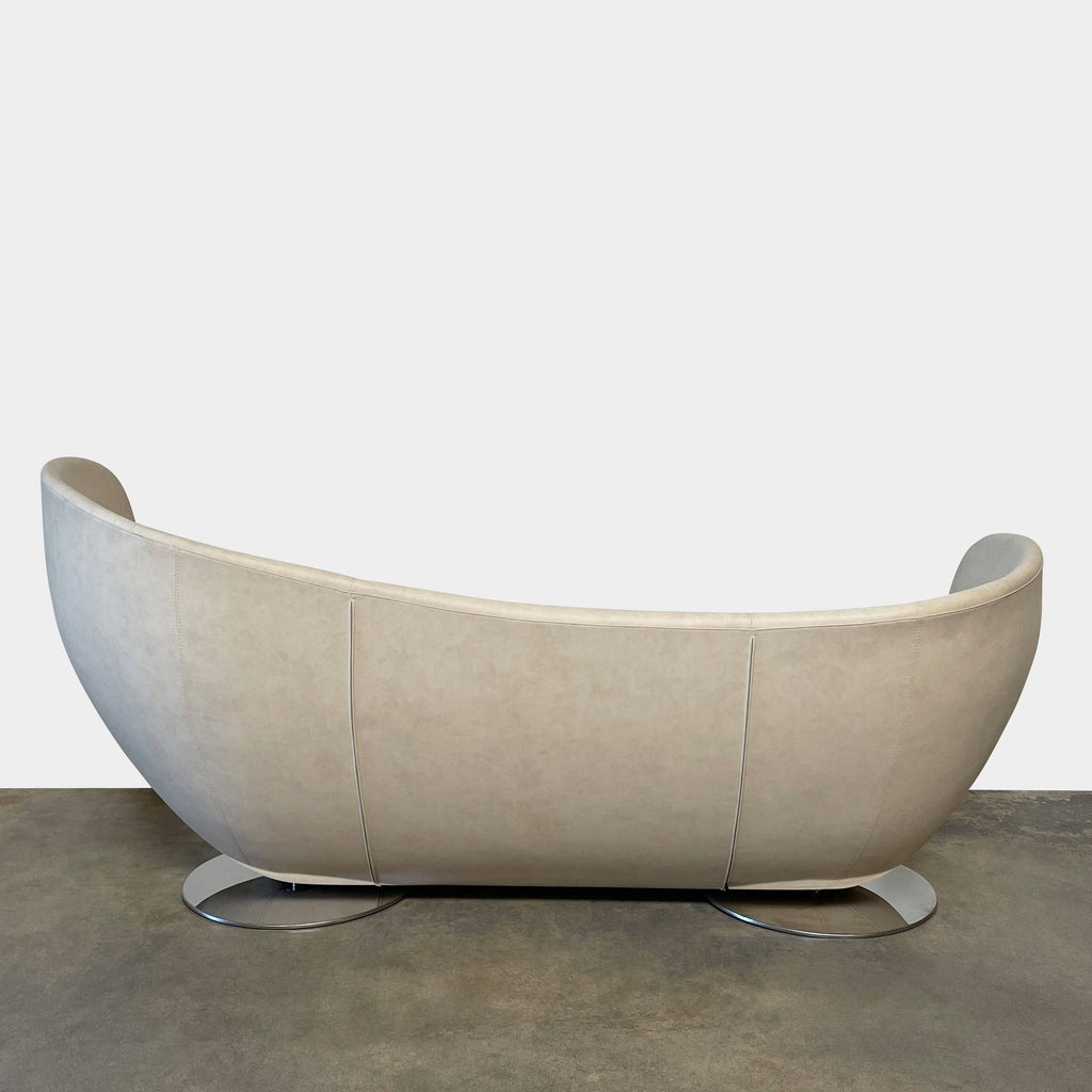 Modern curved La Cividina Mon Coeur sofa isolated on a white background.