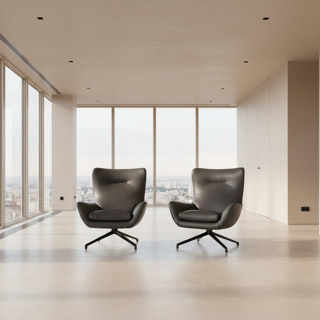 The Minotti Jensen Swivel Armchair features black leather upholstery, a high backrest, and angled metal legs by Minotti, displayed against a plain white background.