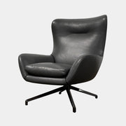 The Minotti Jensen Swivel Armchair features black leather upholstery, a high backrest, and angled metal legs by Minotti, displayed against a plain white background.