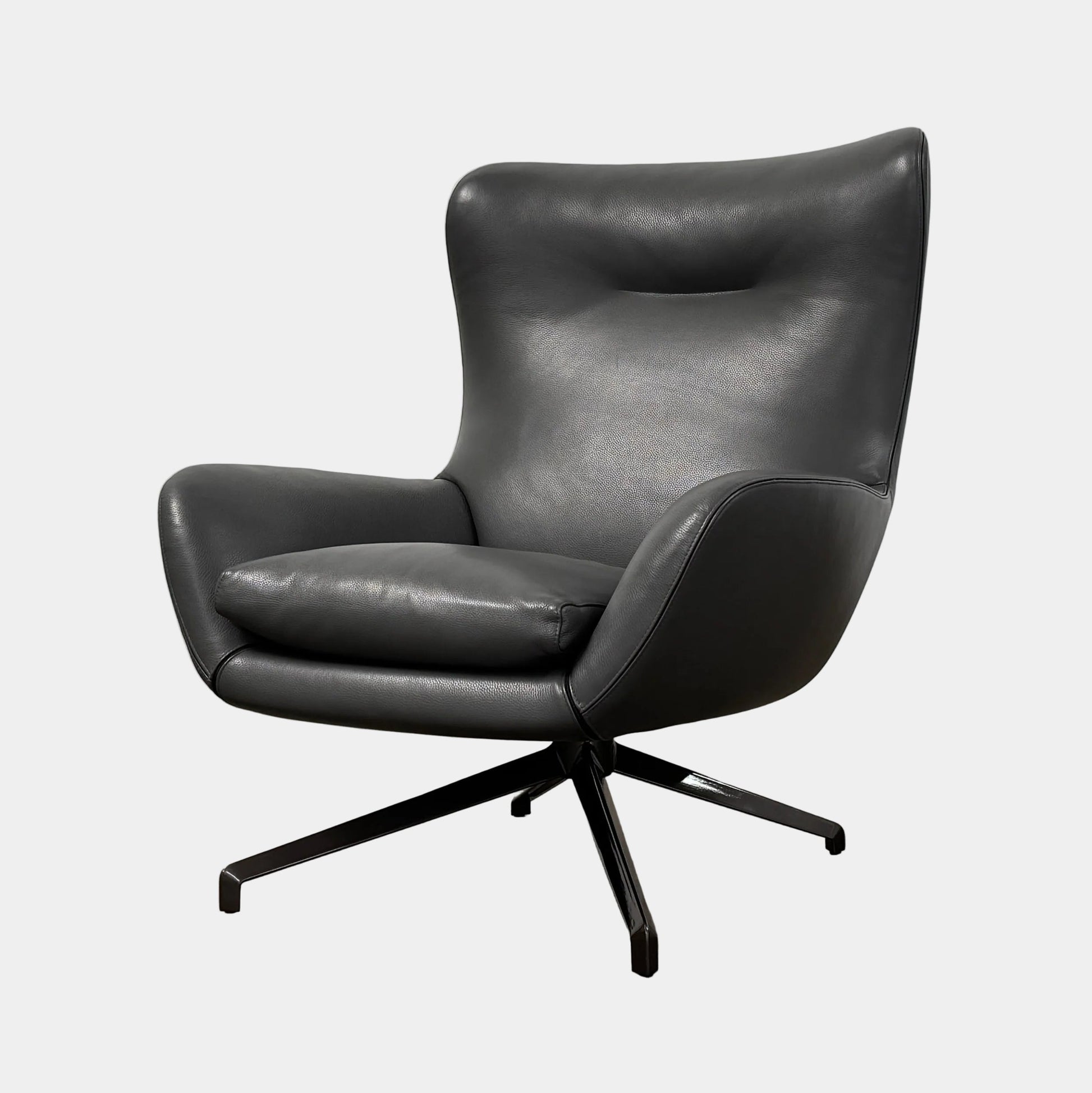 The Minotti Jensen Swivel Armchair features black leather upholstery, a high backrest, and angled metal legs by Minotti, displayed against a plain white background.
