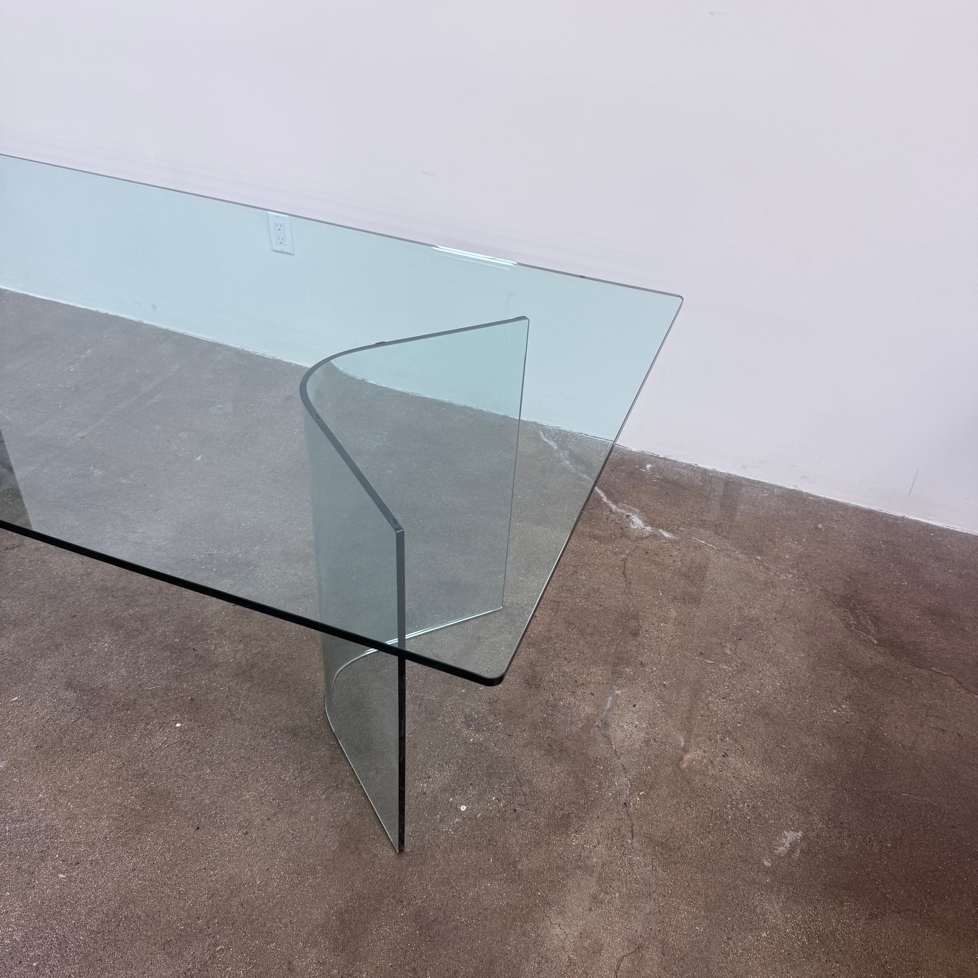 Fiam Italia Corner Dining Table, a rectangular glass table with two curved glass pedestal bases.