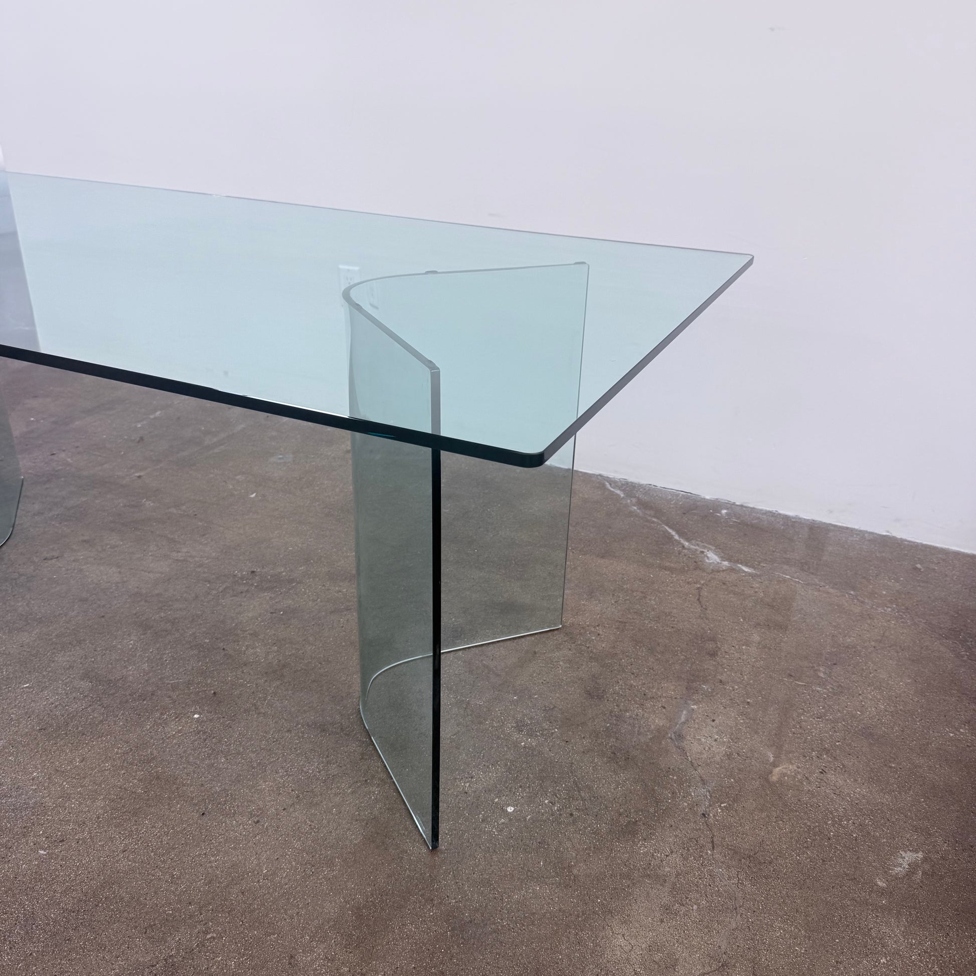 Fiam Italia Corner Dining Table, a rectangular glass table with two curved glass pedestal bases.