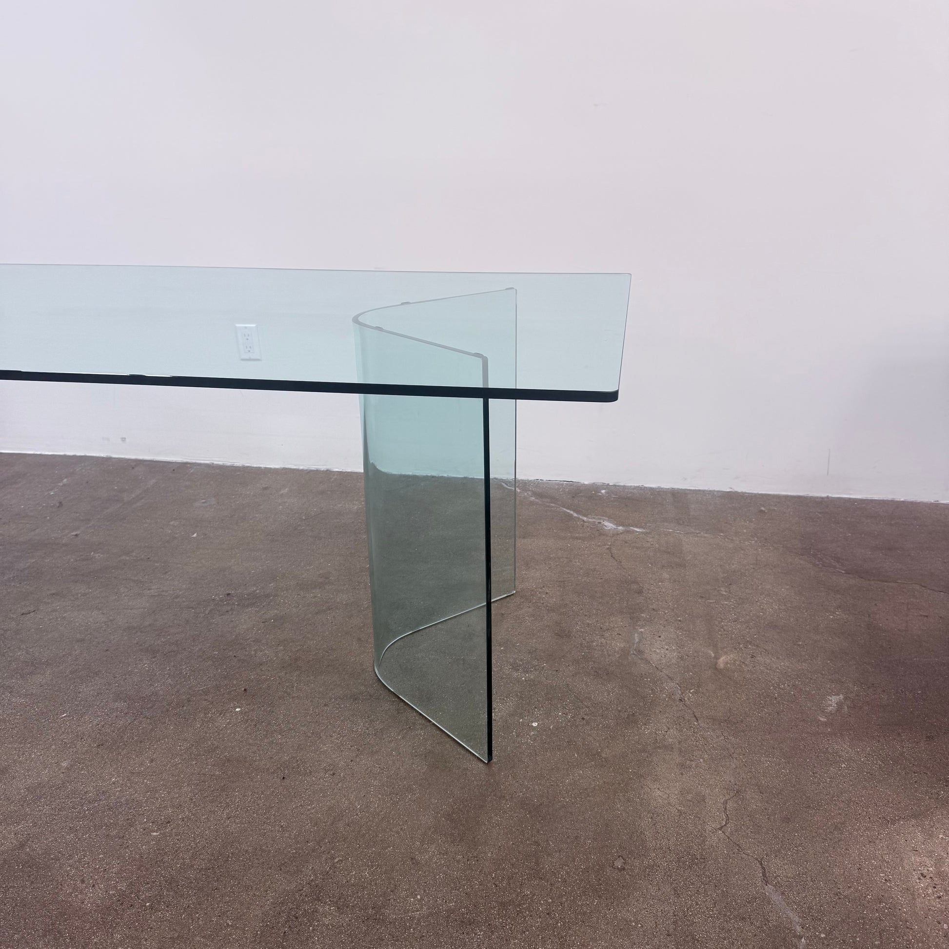 Fiam Italia Corner Dining Table, a rectangular glass table with two curved glass pedestal bases.