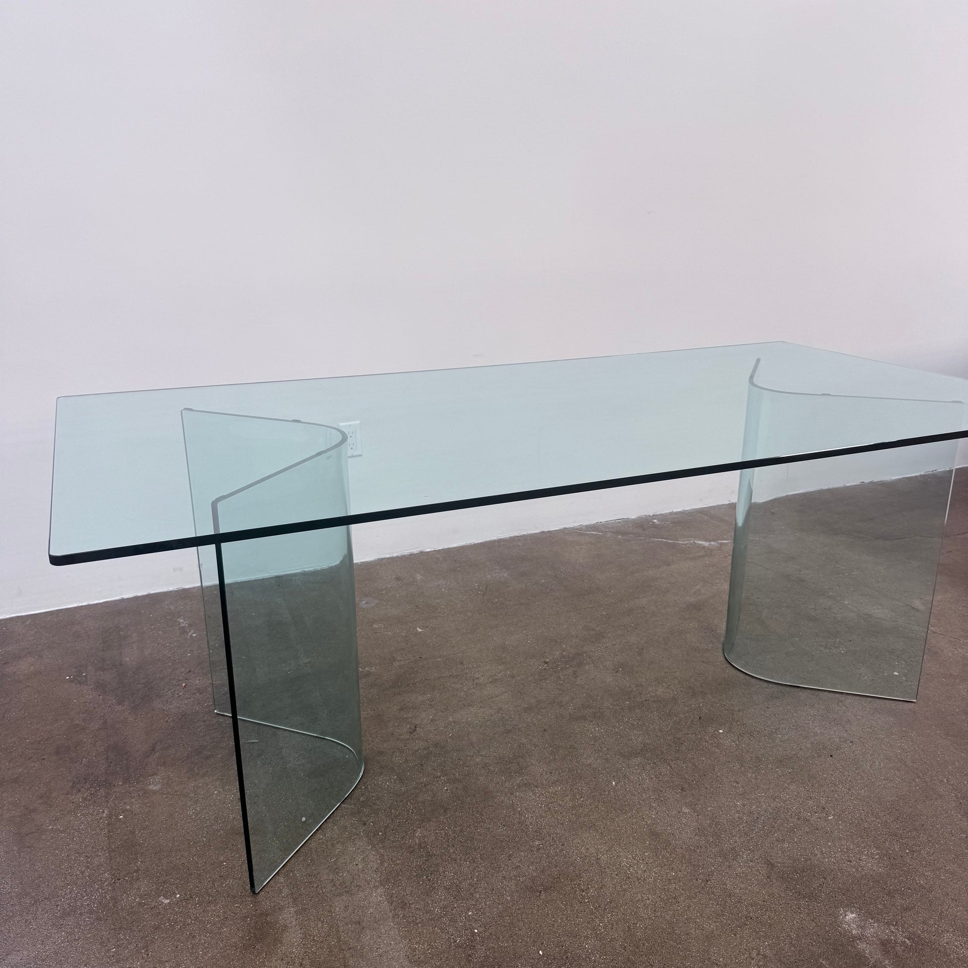 Fiam Italia Corner Dining Table, a rectangular glass table with two curved glass pedestal bases.