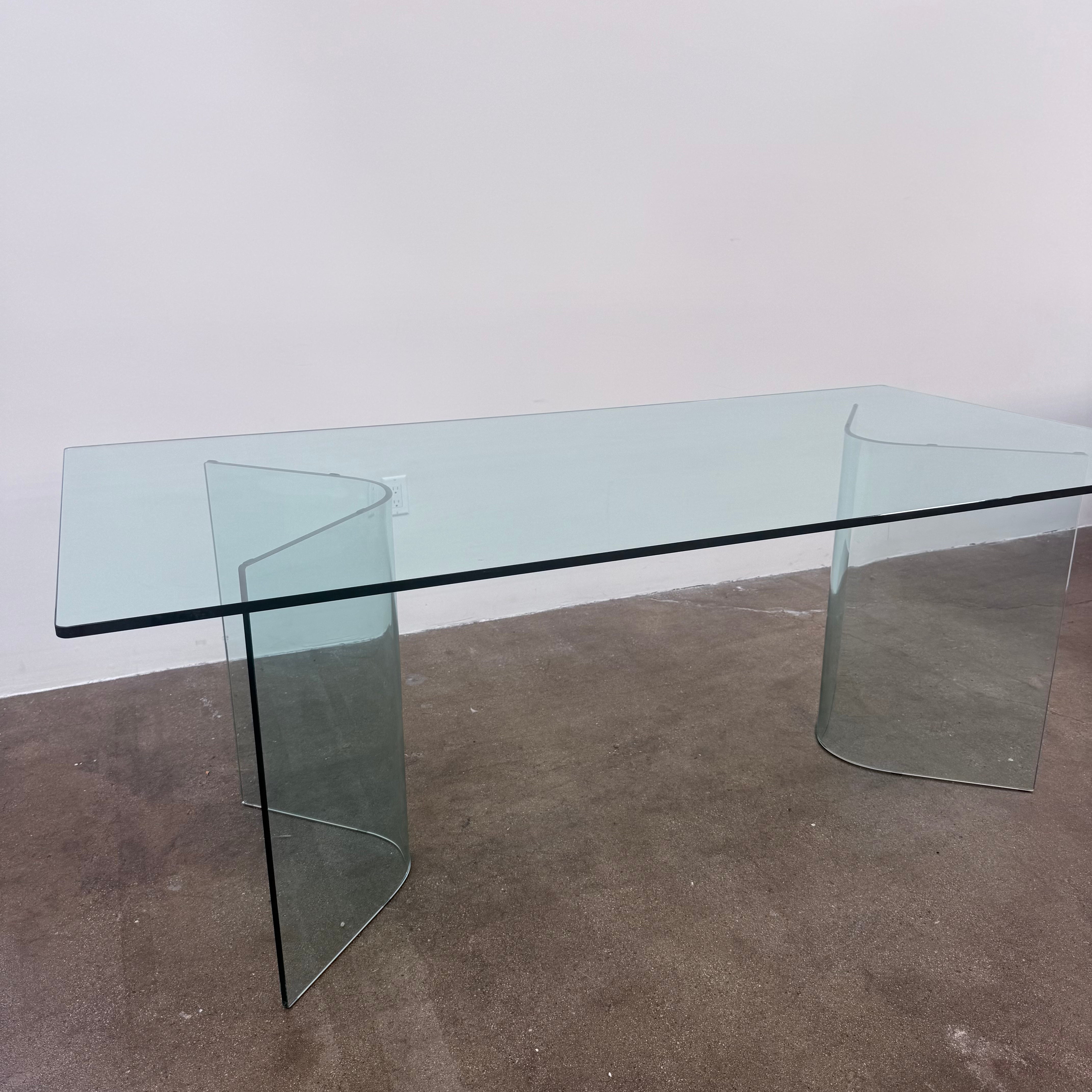Fiam Italia Corner Dining Table, a rectangular glass table with two curved glass pedestal bases.