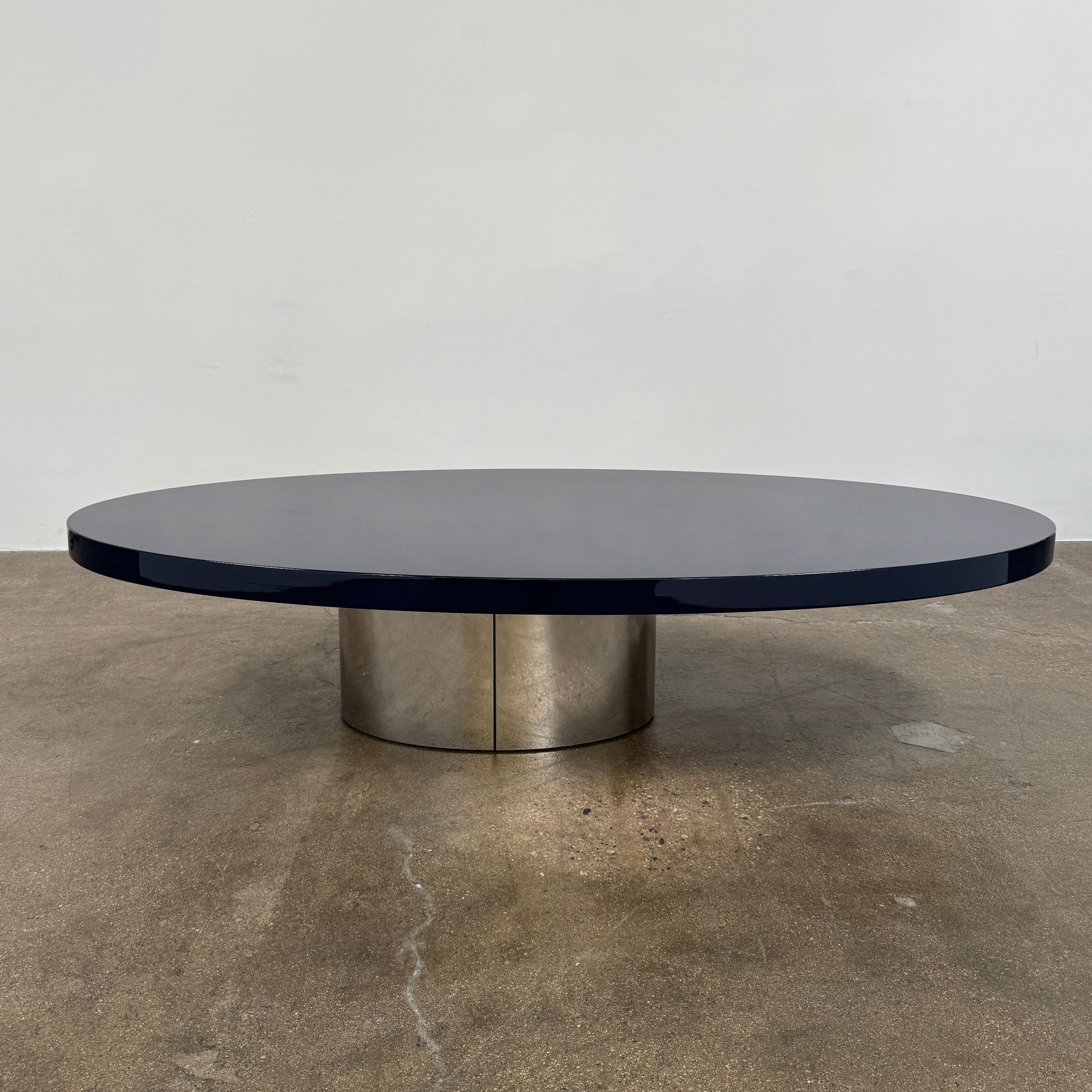 A sleek Minotti Raymond Coffee Table with a metal base, exhibiting clean shapes and proportions.